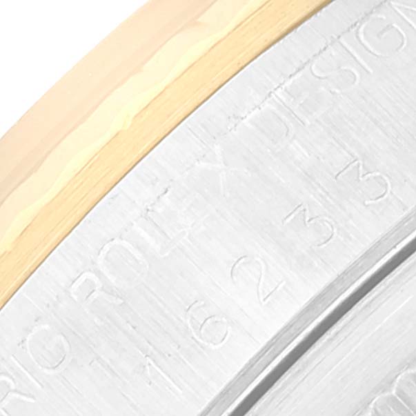 This image shows a close-up of the engraved bezel and part of the case back of a Rolex Datejust 16233 Men's Steel and Gold (two tone) Champagne Dial 16233 Men's Steel and Gold (two tone) Champagne Dial watch.