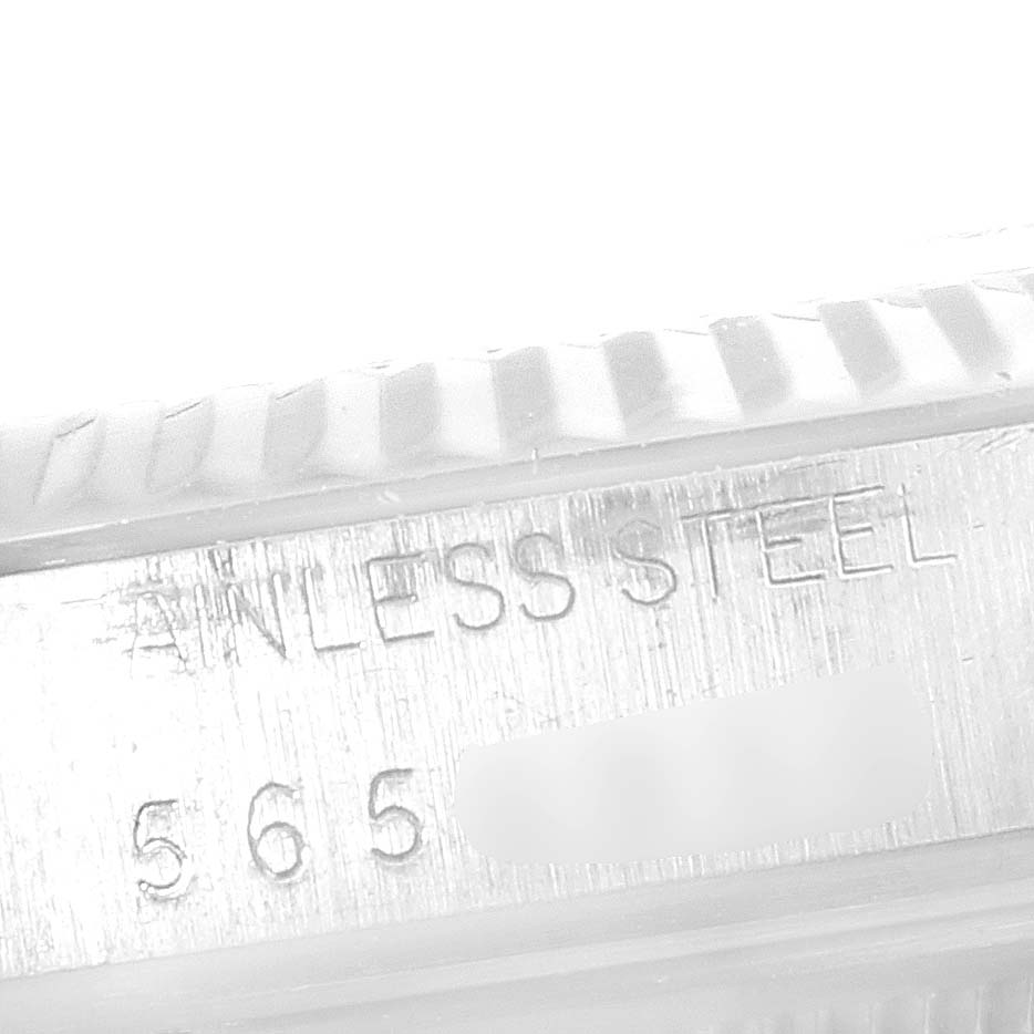 The image shows a close-up angle of the "Vintage Collection" by Rolex, focusing on the stainless steel part with engraved text.