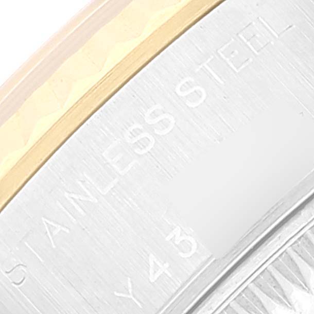 This is a close-up of the bezel and sidecase of a Rolex Datejust 79173 Women's Steel and Gold (two tone) Black Dial 79173 Women's Steel and Gold (two tone) Black Dial, showing the "STAINLESS STEEL" engraving.