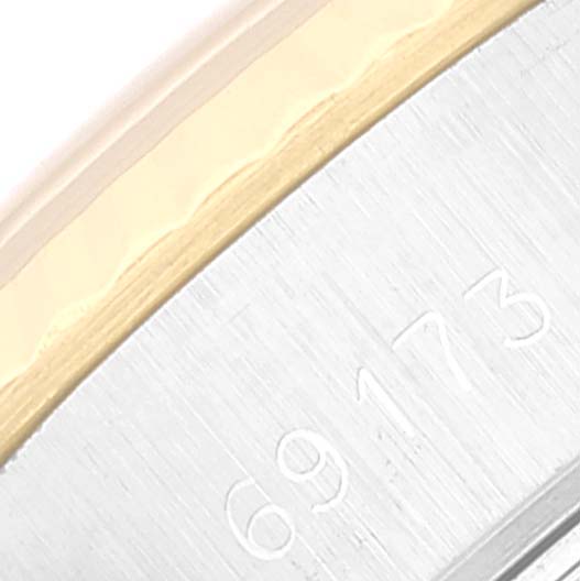 This close-up image shows part of the bezel with a brushed finish and engraved serial numbers on a Rolex Datejust 69173 Women's Steel and Gold (two tone) Champagne Dial 69173 Women's Steel and Gold (two tone) Champagne Dial watch.