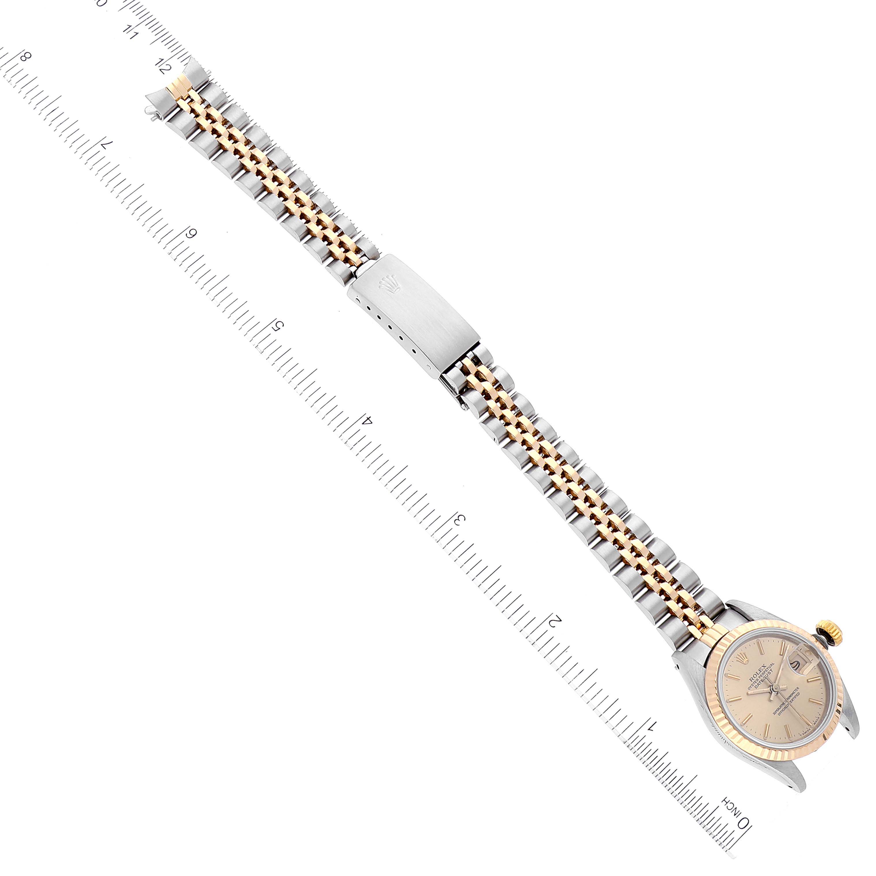 The image shows a Rolex Datejust 69173 Women's Steel and Gold (two tone) Champagne Dial 69173 Women's Steel and Gold (two tone) Champagne Dial watch laid flat with its full bracelet and clasp visible, alongside a measuring ruler.