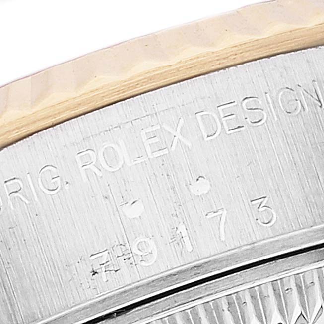 This is a close-up of the case back edge, showcasing the "ORIG. ROLEX DESIGN" engraving on the Rolex Datejust 79173 Women's Steel and Gold (two tone) Champagne Dial 79173 Women's Steel and Gold (two tone) Champagne Dial watch.