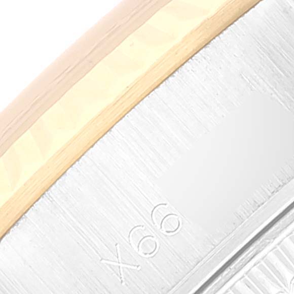 This is a close-up of the side of a Rolex Datejust 69173 Women's Steel and Gold (two tone) Champagne Dial 69173 Women's Steel and Gold (two tone) Champagne Dial watch, highlighting the edge and part of the case's serial number.