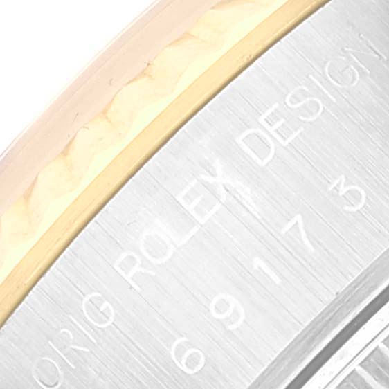This close-up shows the engraved side of the bezel or case of a Rolex Datejust 69173 Women's Steel and Gold (two tone) White Dial 69173 Women's Steel and Gold (two tone) White Dial watch.