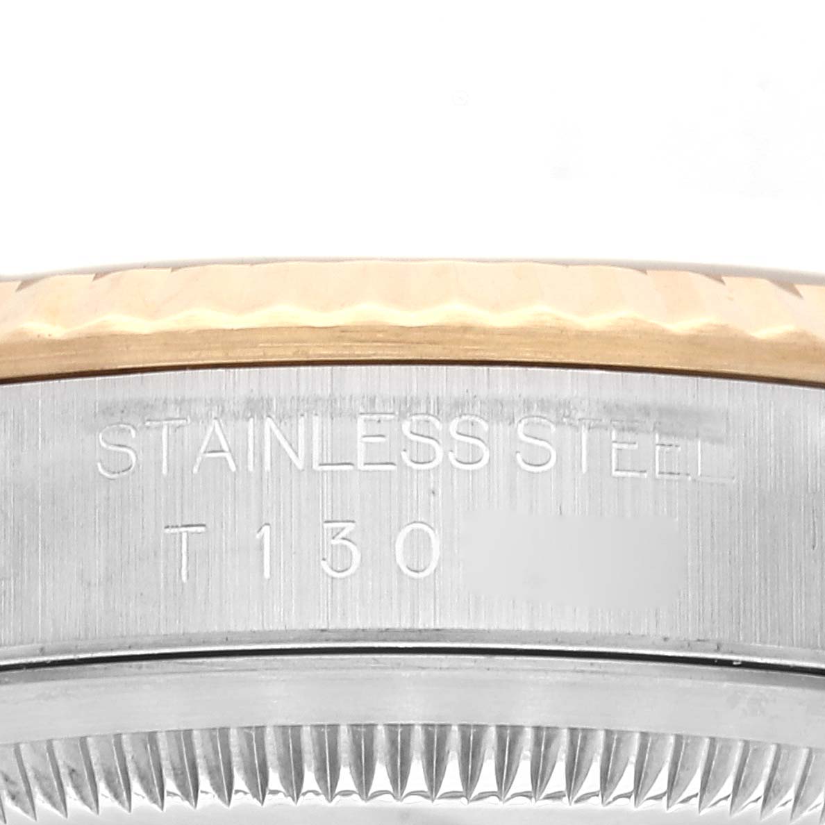 This image shows a close-up of the side casing of a Rolex Datejust 16233 Men's Steel and Gold (two tone) White Dial 16233 Men's Steel and Gold (two tone) White Dial watch, displaying its "STAINLESS STEEL" inscription.