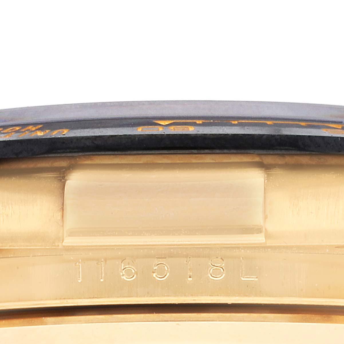 The image shows a close-up side view of the bezel and case of a Rolex Daytona 116518 Men's Yellow Gold White Dial 116518 Men's Yellow Gold White Dial watch.