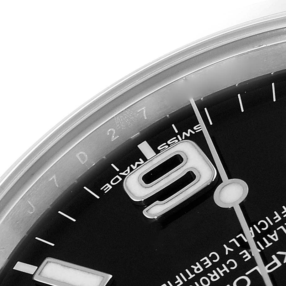 The image shows a close-up of the dial and bezel of the Rolex Explorer 214270 Men's Stainless Steel Black Dial 214270 Men's Stainless Steel Black Dial model, focusing on the "Swiss Made" text and the number "9."