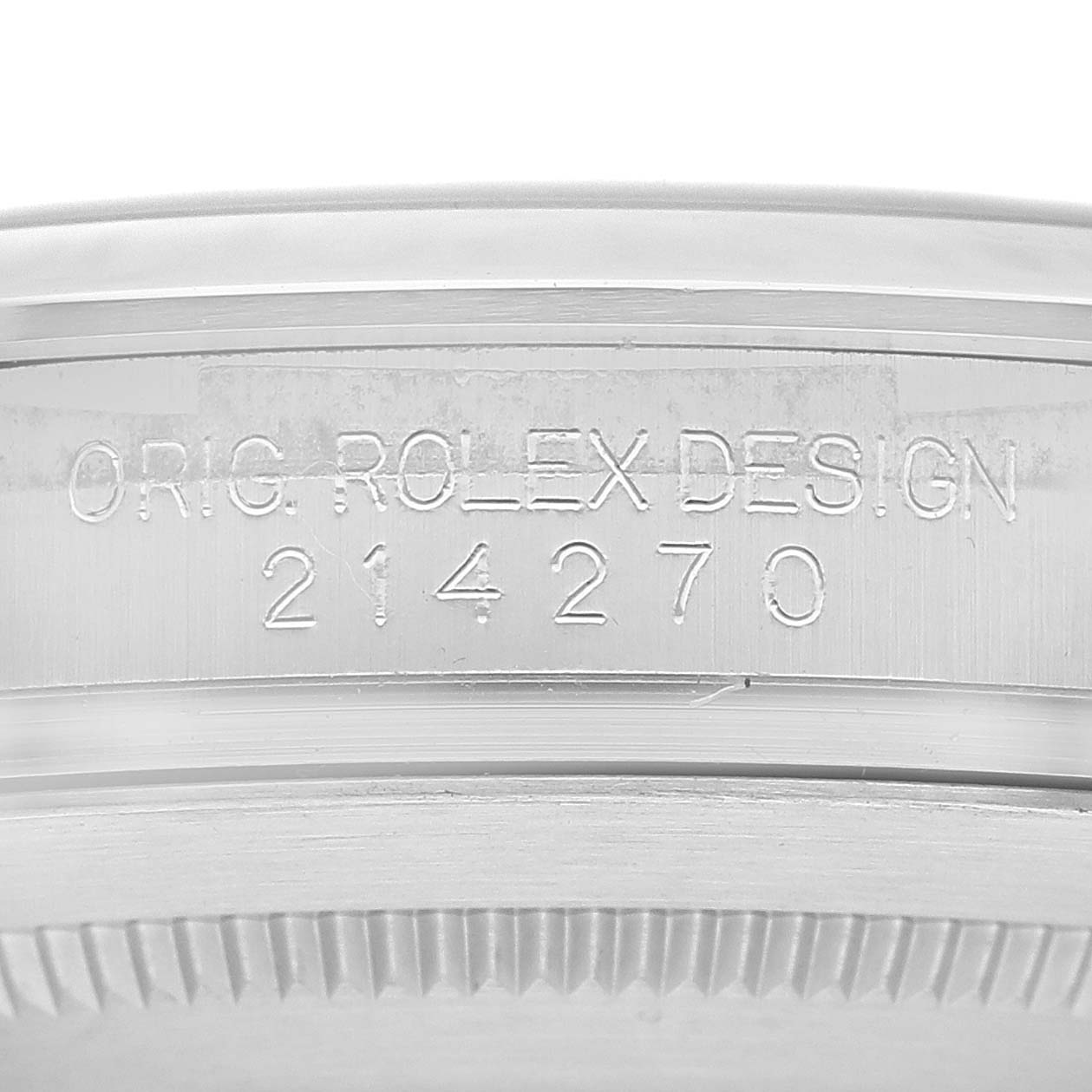 A close-up of a Rolex Explorer 214270 Men's Stainless Steel Black Dial 214270 Men's Stainless Steel Black Dial watch showing the engraved "ORIG. ROLEX DESIGN" and model number 214270 on the case.