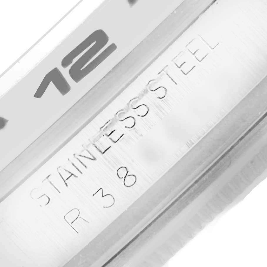 The image shows a close-up of the bezel and the inner ring of the Rolex Explorer 16550 Men's Stainless Steel White Dial 16550 Men's Stainless Steel White Dial, with "12" and "STAINLESS STEEL" engraving visible.