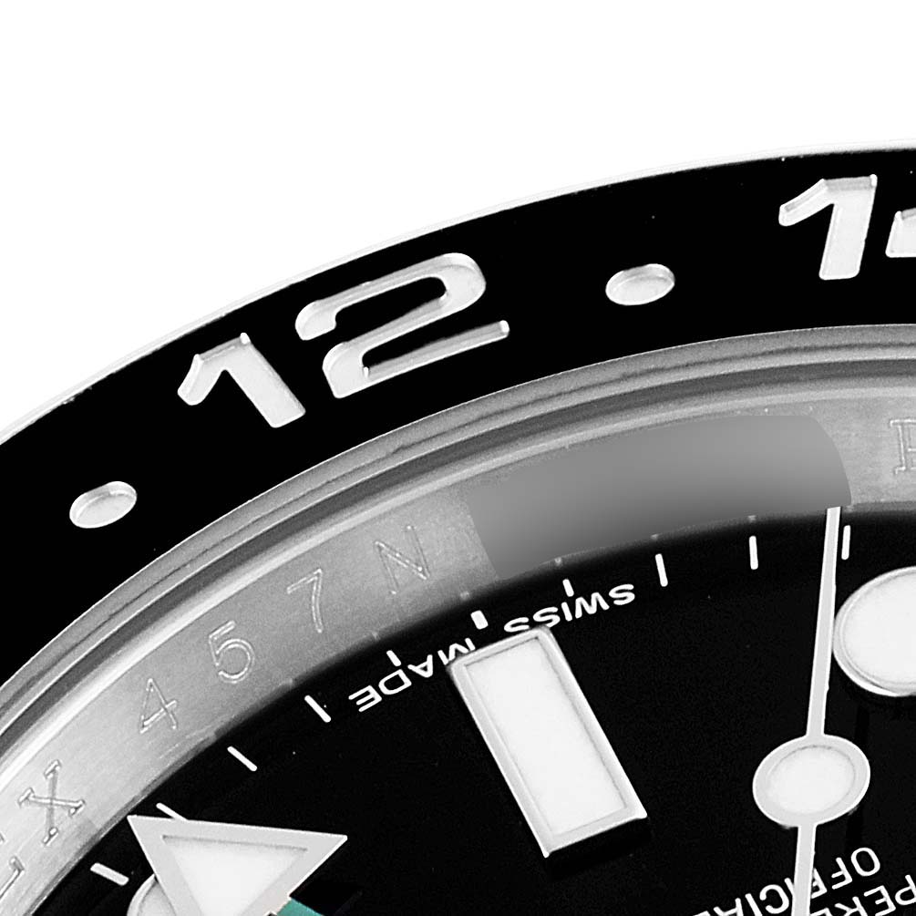 The image shows a close-up of the bezel and part of the dial of a Rolex GMT-Master 116710 Men
s Stainless Steel Black Dial 116710 Men
s Stainless Steel Black Dial watch, highlighting the 12 marker.