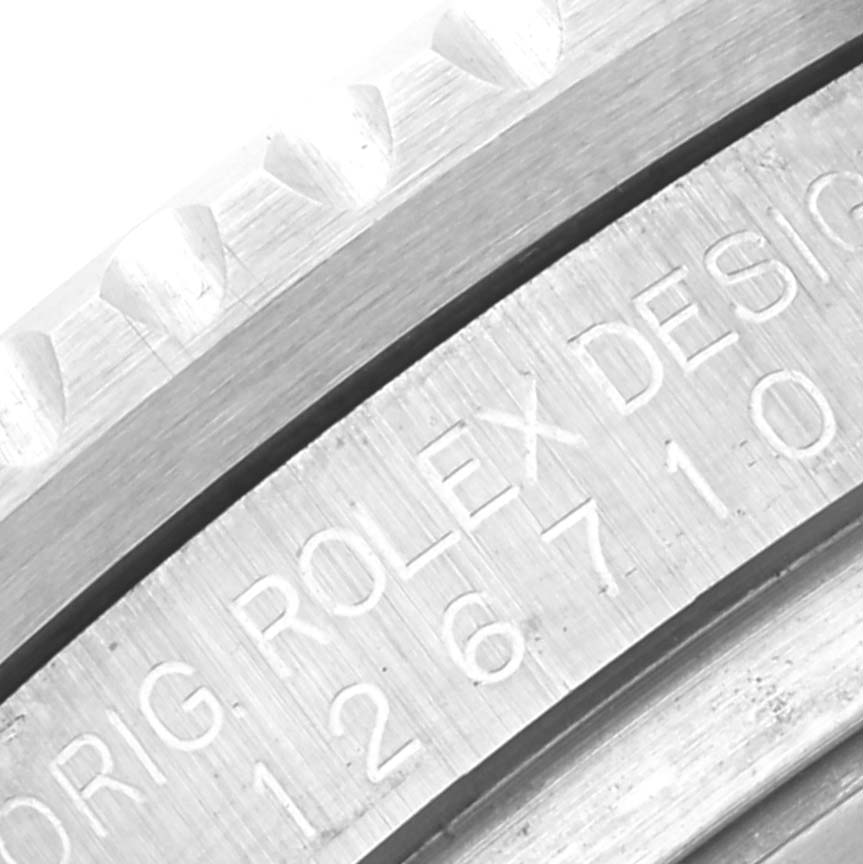 This close-up image shows the engraved bezel and case of a Rolex GMT-Master 126710BLRO Men's Stainless Steel Black Dial 126710BLRO Men's Stainless Steel Black Dial watch.