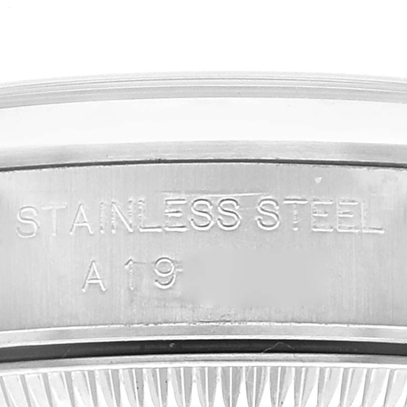 The image shows a close-up view of the case back of a Rolex Oyster Perpetual 76080 Women's Stainless Steel Black Dial 76080 Women's Stainless Steel Black Dial watch, highlighting the stainless steel marking.