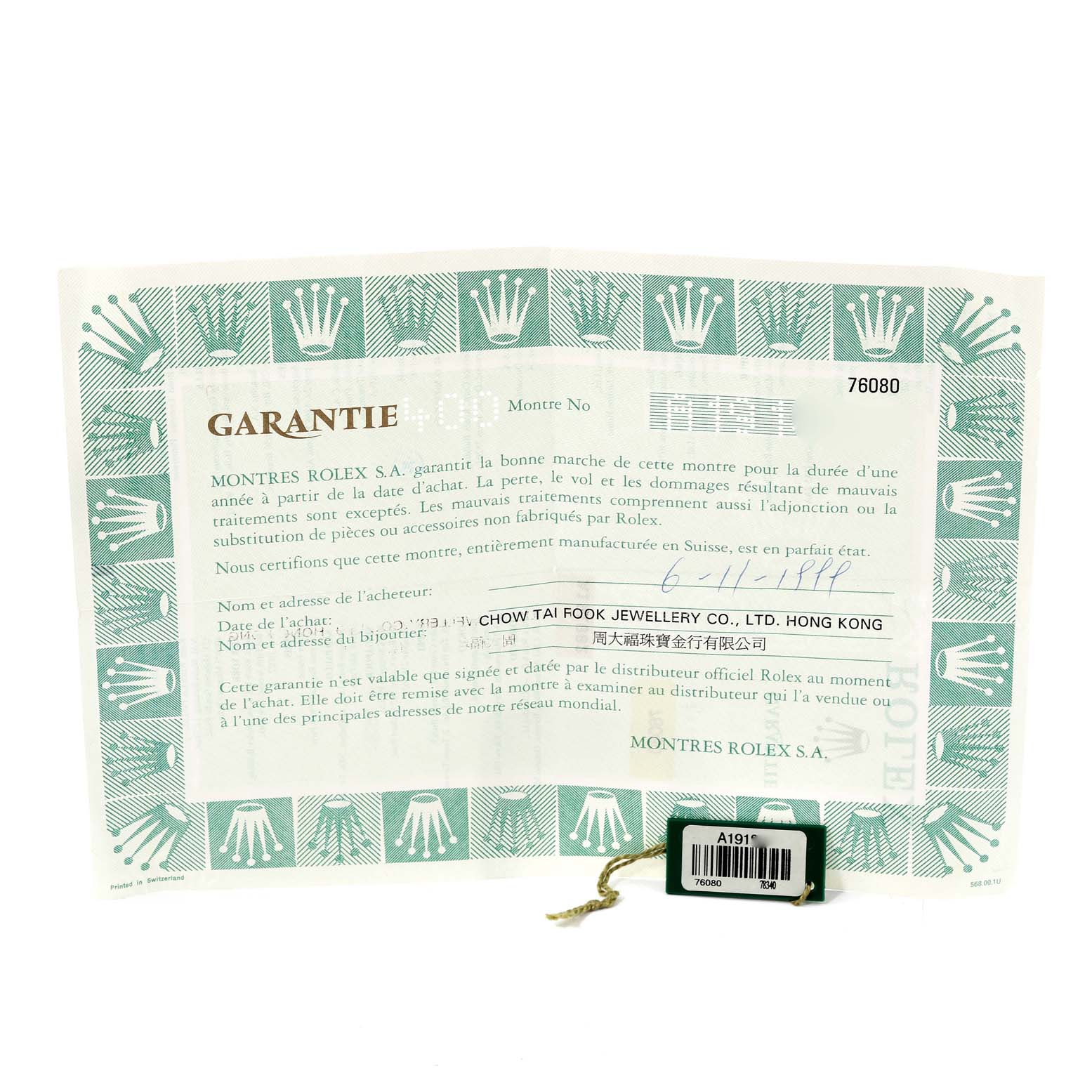 This image shows a warranty certificate and a hang tag for the Rolex Oyster Perpetual 76080 Women's Stainless Steel Black Dial 76080 Women's Stainless Steel Black Dial model.