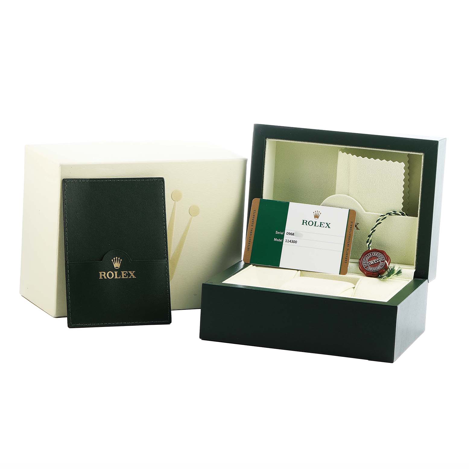 The image shows the packaging and accessories for a Rolex Oyster Perpetual 114300 Men's Stainless Steel Grey Dial, including the box, warranty card, and booklet.