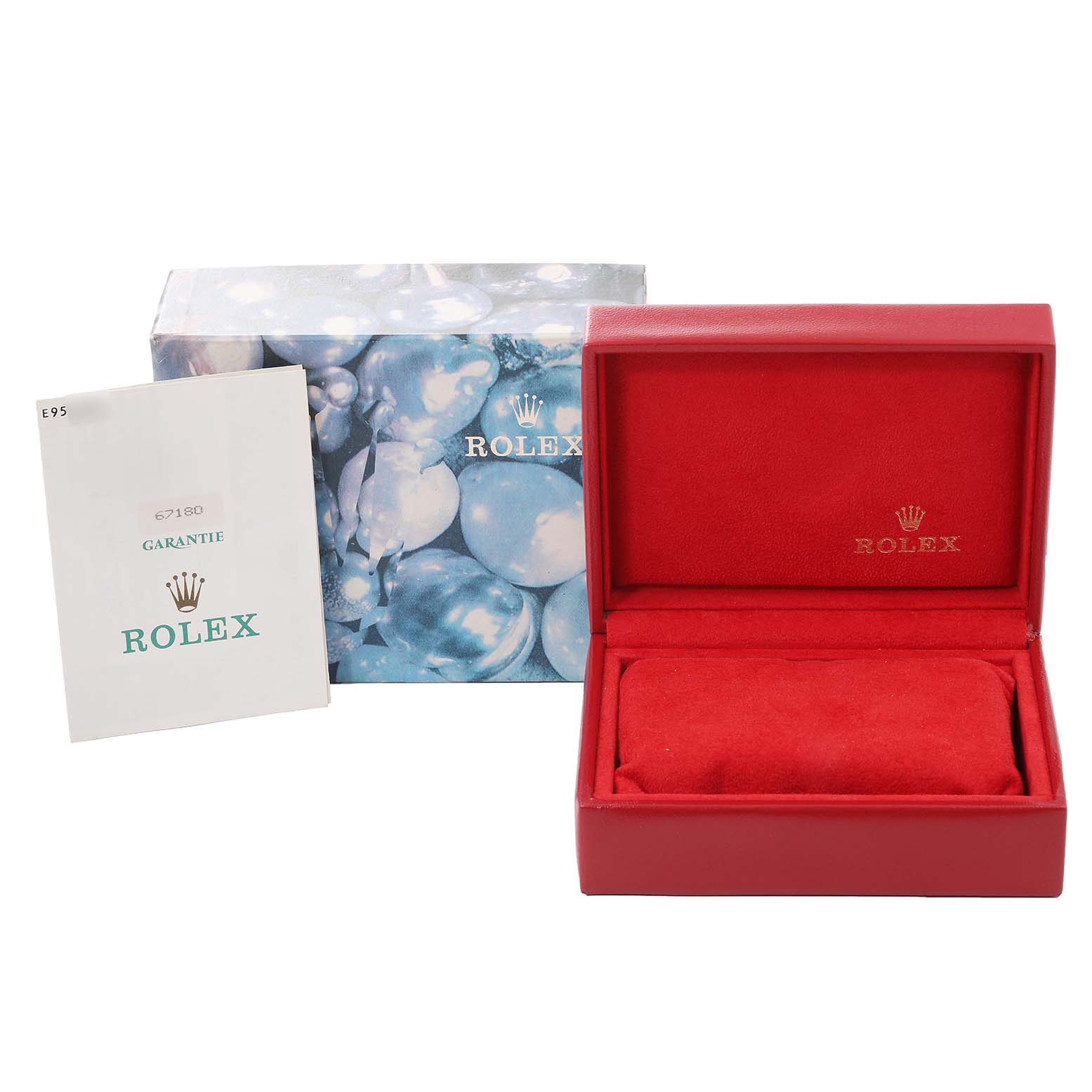 This image shows the packaging and accessories for a Rolex Oyster Perpetual 67180 Women
s Stainless Steel Blue Dial 67180 Women
s Stainless Steel Blue Dial, including a watch box and a warranty booklet.