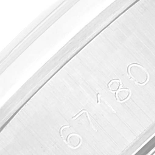 This is a close-up shot of the underside of a Rolex Oyster Perpetual 67180 Women
s Stainless Steel Blue Dial 67180 Women
s Stainless Steel Blue Dial watch band, displaying engraved numbers "67" and "80."