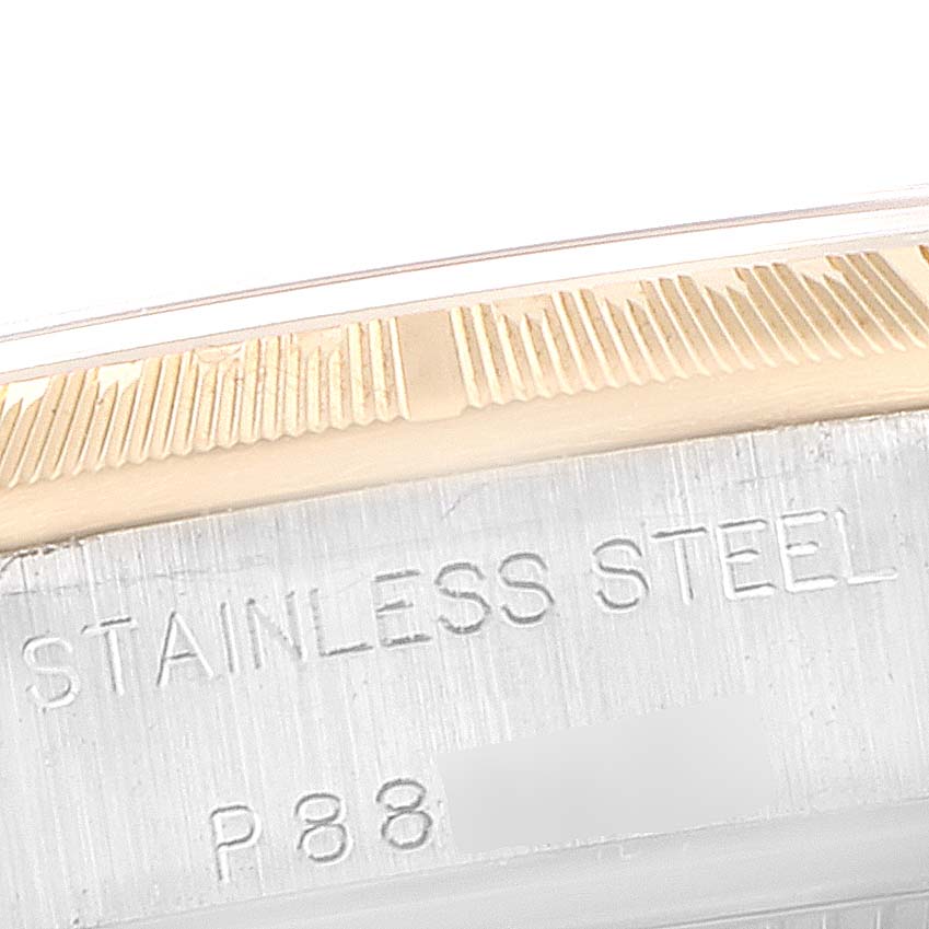 This image shows a close-up of the side of a Rolex Oyster Perpetual 76243 Women's Steel and Gold (two tone) Silver Dial 76243 Women's Steel and Gold (two tone) Silver Dial watch's case, featuring the stainless steel material.