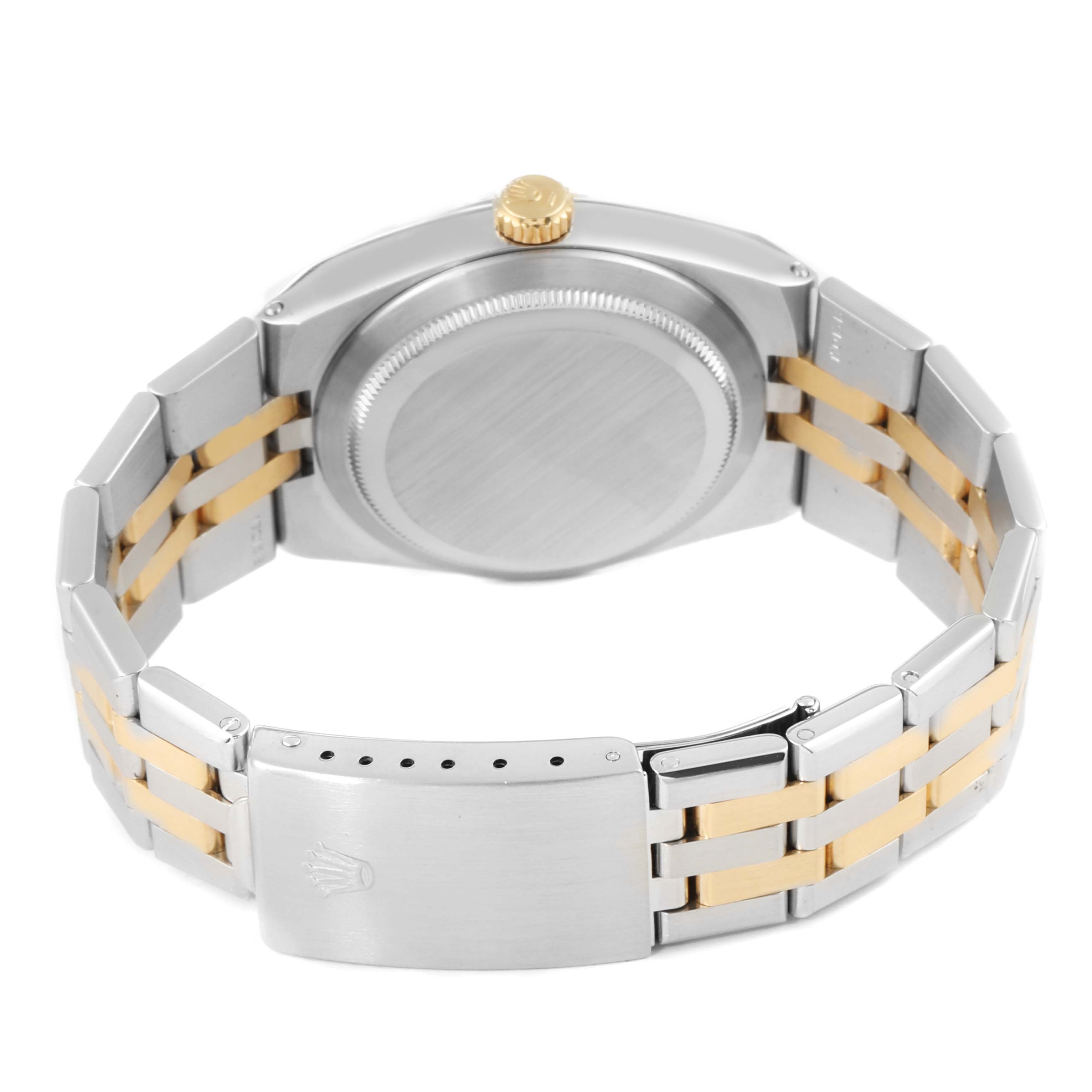 The image shows the Oysterquartz model by Rolex from a rear angle, highlighting the case back, crown, and two-tone metal bracelet.