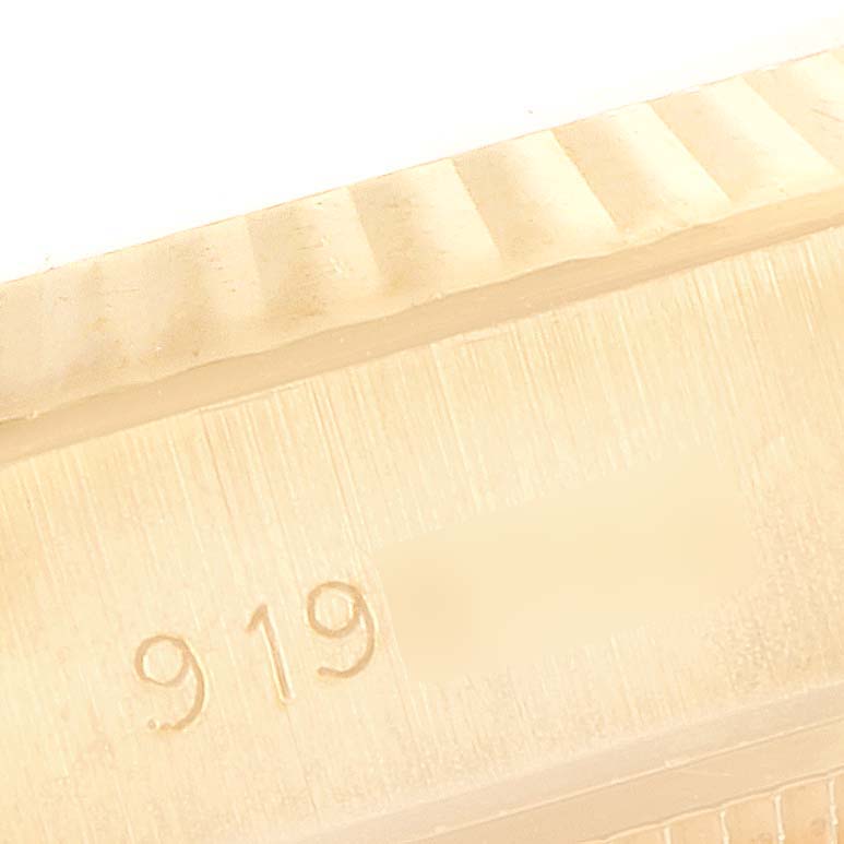 This close-up image shows the fluted bezel and part of the serial number of a Rolex President 69178 Women
s Yellow Gold Champagne Dial 69178 Women
s Yellow Gold Champagne Dial model watch.