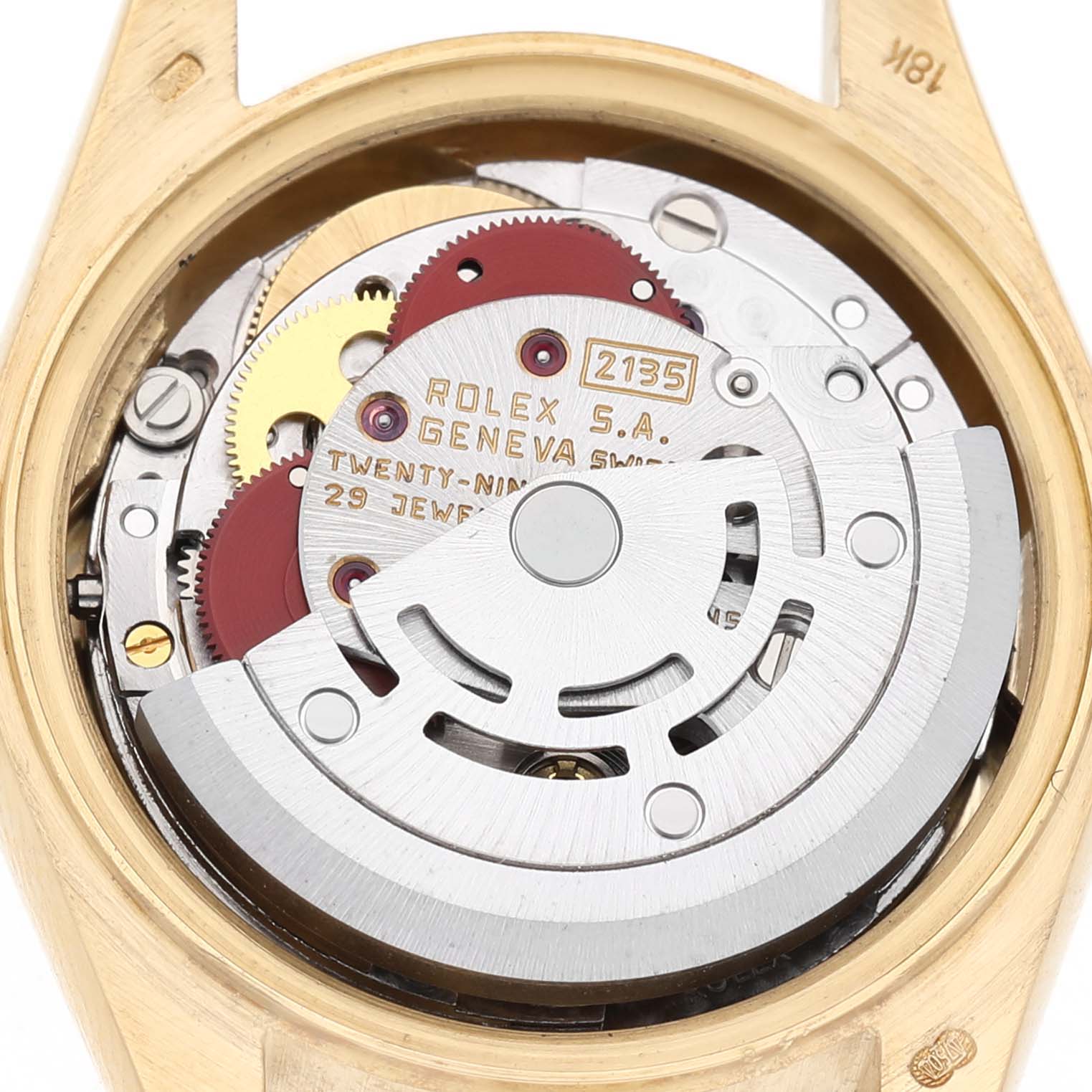 The image shows the movement of a Rolex President 69178 Women's Yellow Gold Champagne Dial model watch from the back, highlighting gears and the rotor.