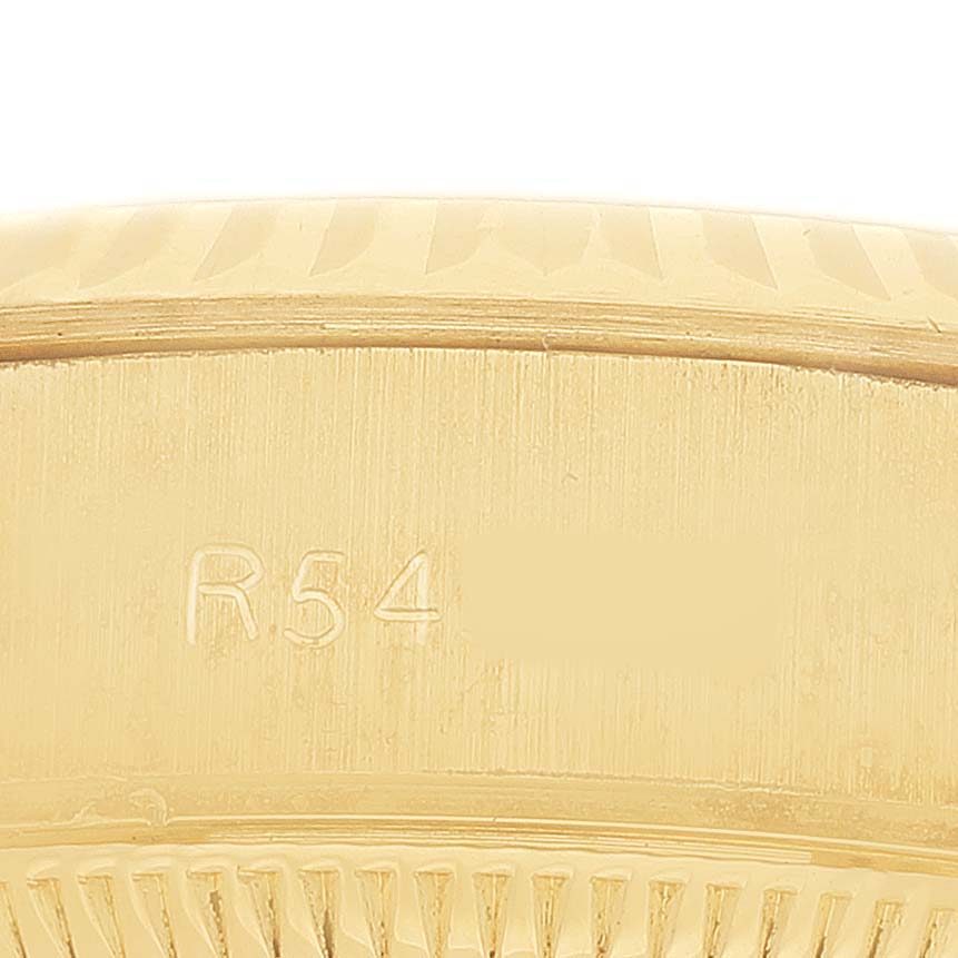 The image shows a close-up of the edge and engraved serial number of the Rolex President 69178 Women's Yellow Gold Champagne Dial watch in gold.
