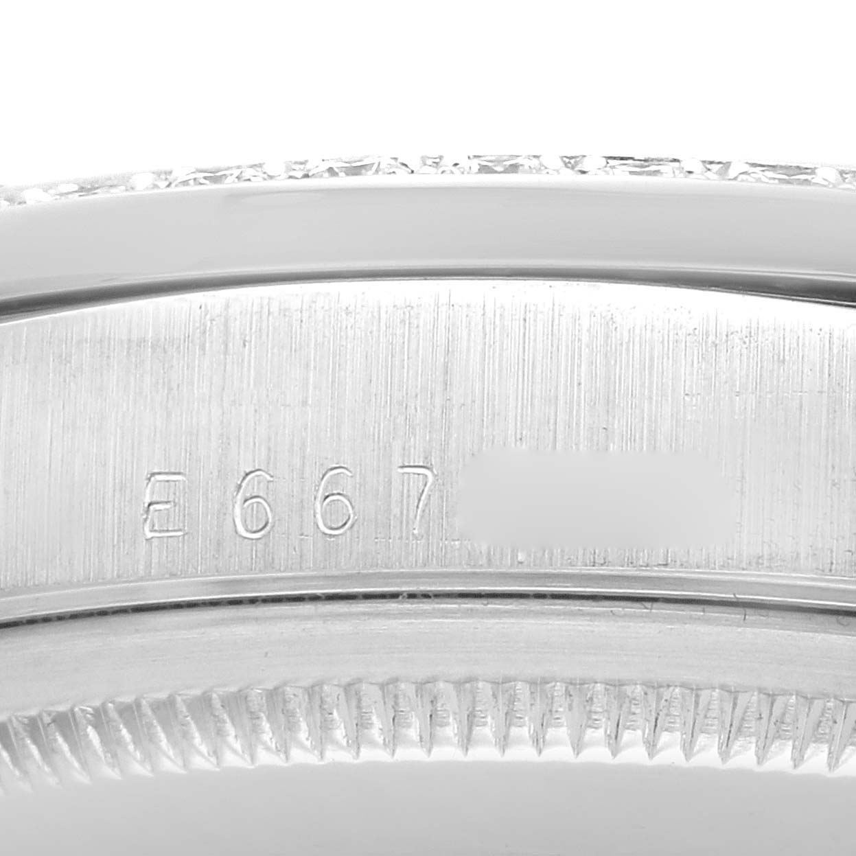 This image shows a close-up of the serial number on the bezel and case of a Rolex President 18346 Men's Platinum Silver Dial 18346 Men's Platinum Silver Dial model watch.