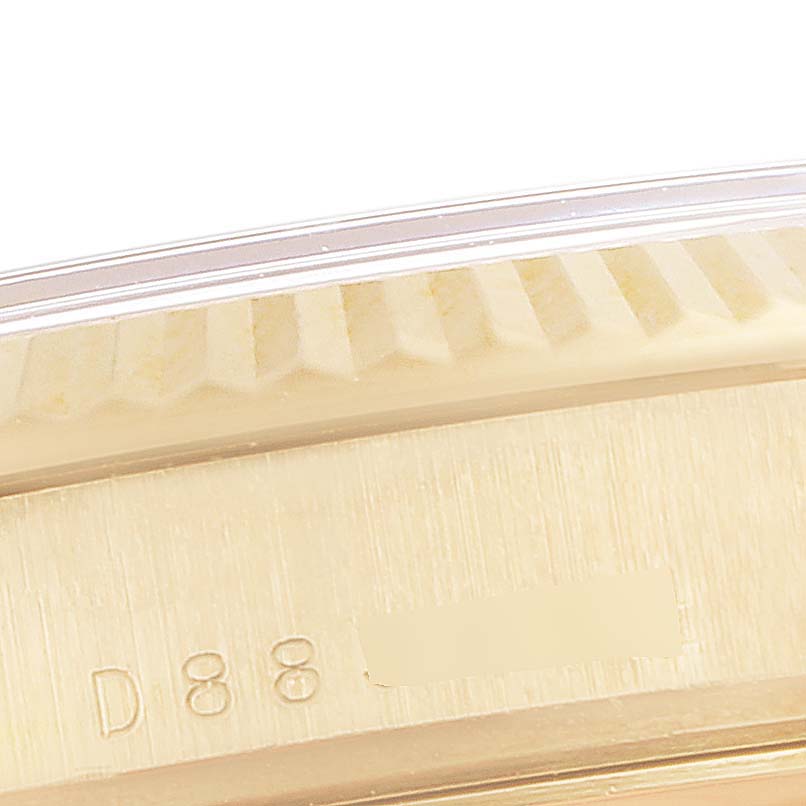 This close-up image shows the serial number on the case side and part of the fluted bezel of a Rolex President 118238 Men
s Yellow Gold Champagne Dial 118238 Men
s Yellow Gold Champagne Dial model watch.