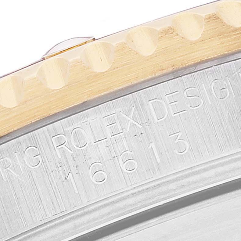 This close-up shows the side view of the bezel and engraved casing of the Rolex Submariner 16613 Men
s Steel and Gold (two tone) Blue Dial 16613 Men
s Steel and Gold (two tone) Blue Dial watch model 16613.