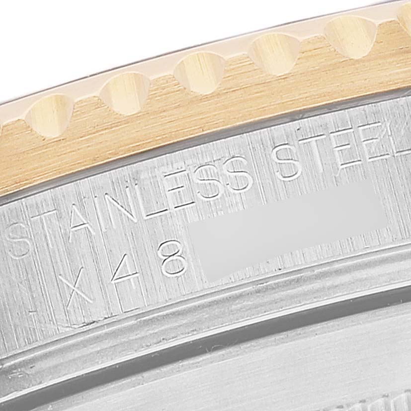 This image shows a close-up of the bezel and edge engraving on a Rolex Submariner 16613 Men
s Steel and Gold (two tone) Blue Dial 16613 Men
s Steel and Gold (two tone) Blue Dial.