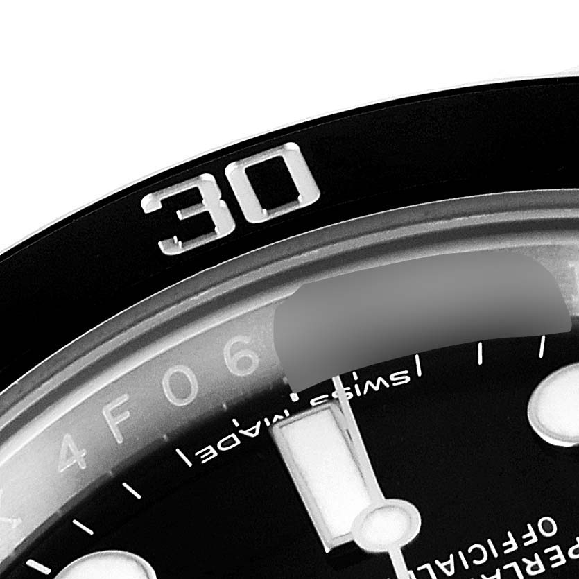 This close-up image of a Rolex Submariner 116610LN Men
s Stainless Steel Black Dial 116610LN Men
s Stainless Steel Black Dial watch shows part of the bezel, the "30" minute mark, and part of the dial.