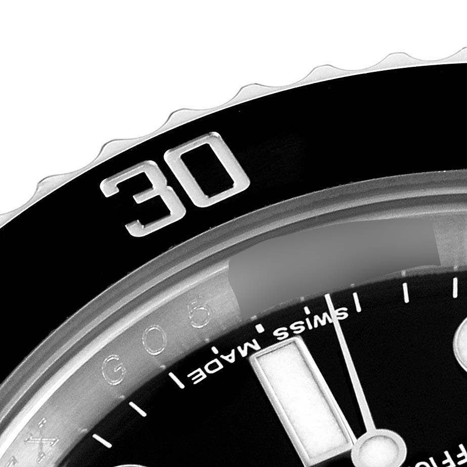 This close-up image of a Rolex Submariner 116610LN Men
s Stainless Steel Black Dial 116610LN Men
s Stainless Steel Black Dial watch shows part of the bezel with the "30" marker and the dial with "SWISS MADE" text.