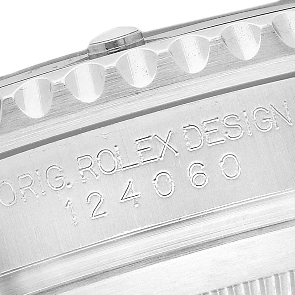 This image shows a close-up of the side of a Rolex Submariner 124060 Men's Stainless Steel Black Dial 124060 Men's Stainless Steel Black Dial 124060, highlighting the engraving and the knurled bezel edge.