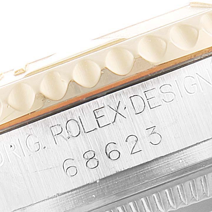 A close-up of the Rolex Yacht-Master 68623 Men
s Steel and Gold (two tone) Grey Dial 68623 Men
s Steel and Gold (two tone) Grey Dial
s side view, showing the etched serial number and edge of the bezel.