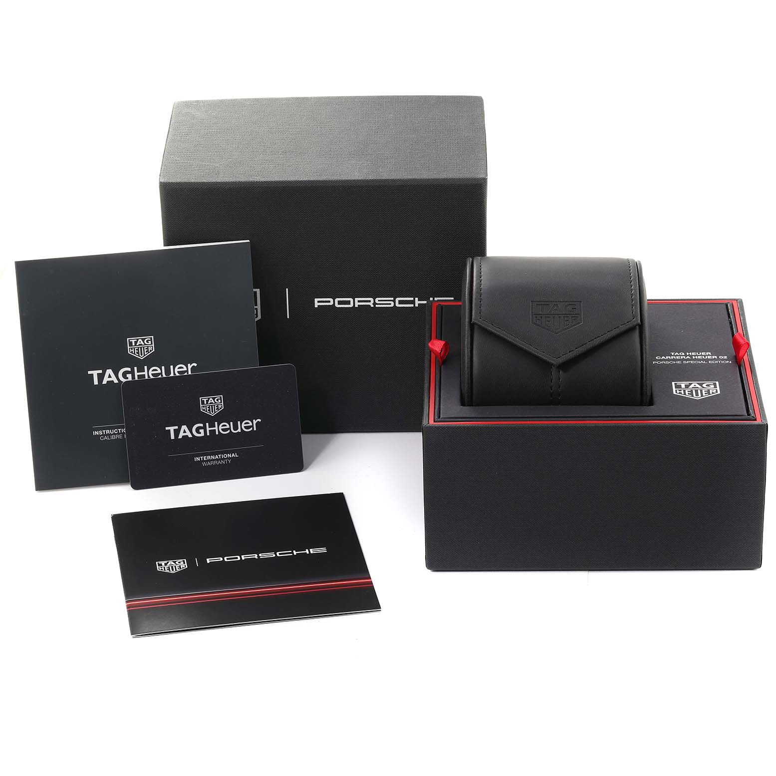 The image shows a boxed set of a Limited Edition Tag Heuer watch model, including packaging, booklets, and warranty cards.