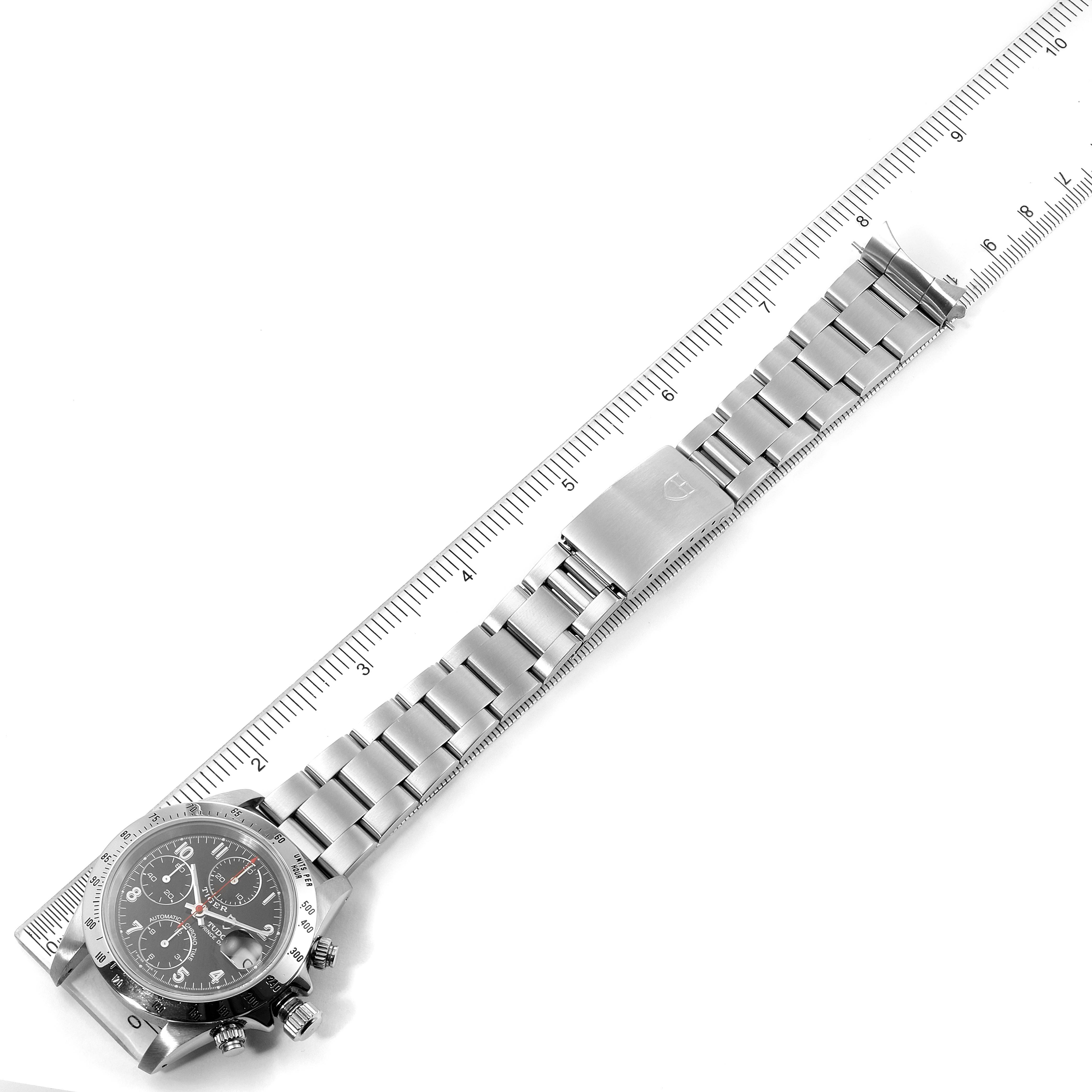 The Tudor Prince watch is displayed flat with its face and stainless steel band visible, aligned with a ruler for measurement.