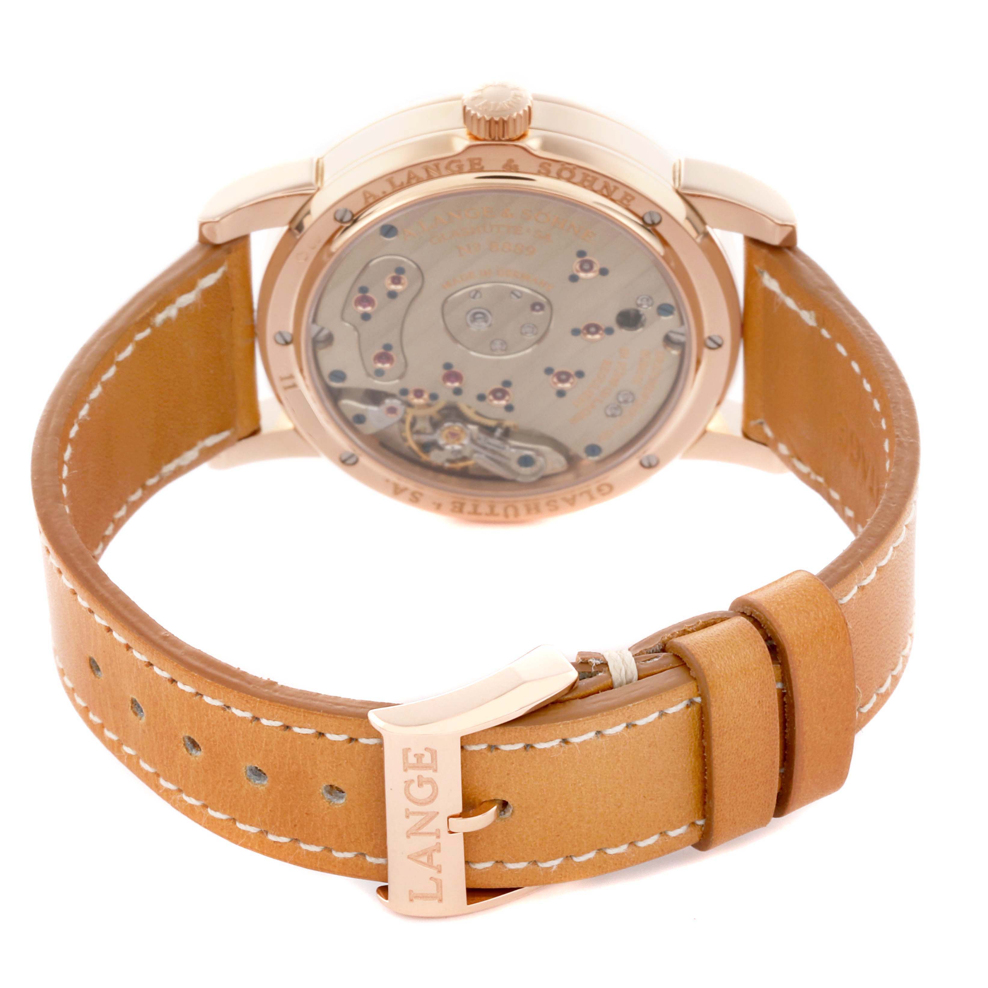 The image shows the back of the A. Lange & Sohne Lange 1 101.032 Men's Rose Gold Silver Dial watch, highlighting its open case back and leather strap with a branded buckle.