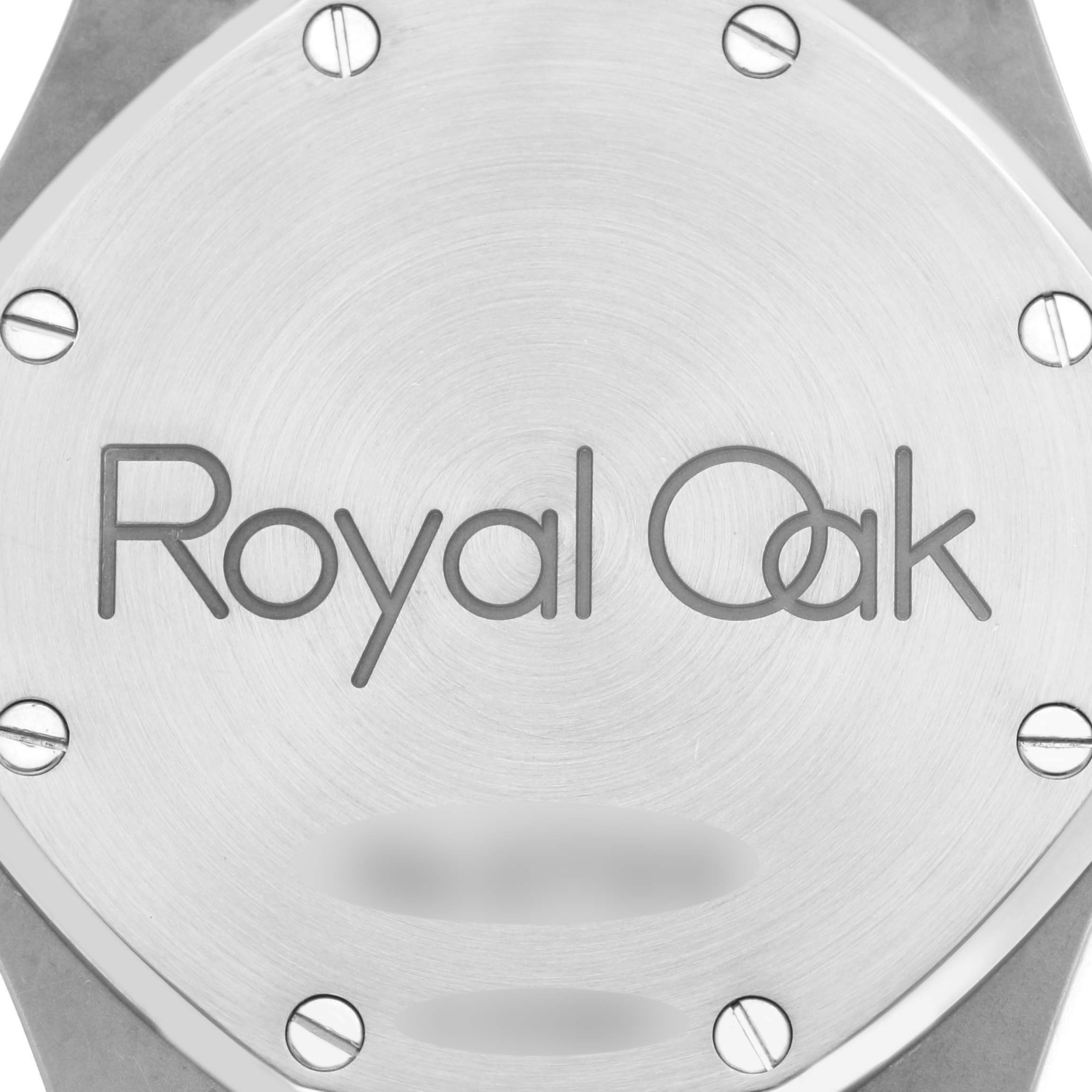 The image shows the back case of a Royal Oak watch by Audemars Piguet, highlighting its brushed metal finish and screw details.