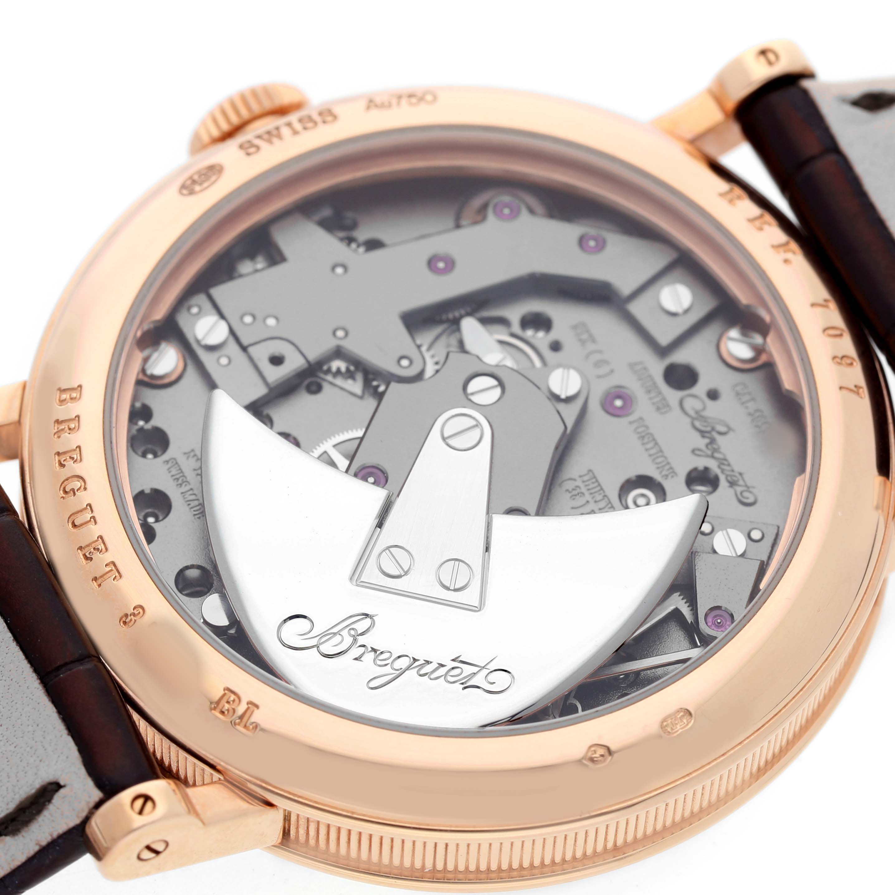 The image shows the back of a Breguet Tradition G7097BR/G1/9WU Men's Rose Gold Silver Dial watch, highlighting the rotor and intricate movement parts.
