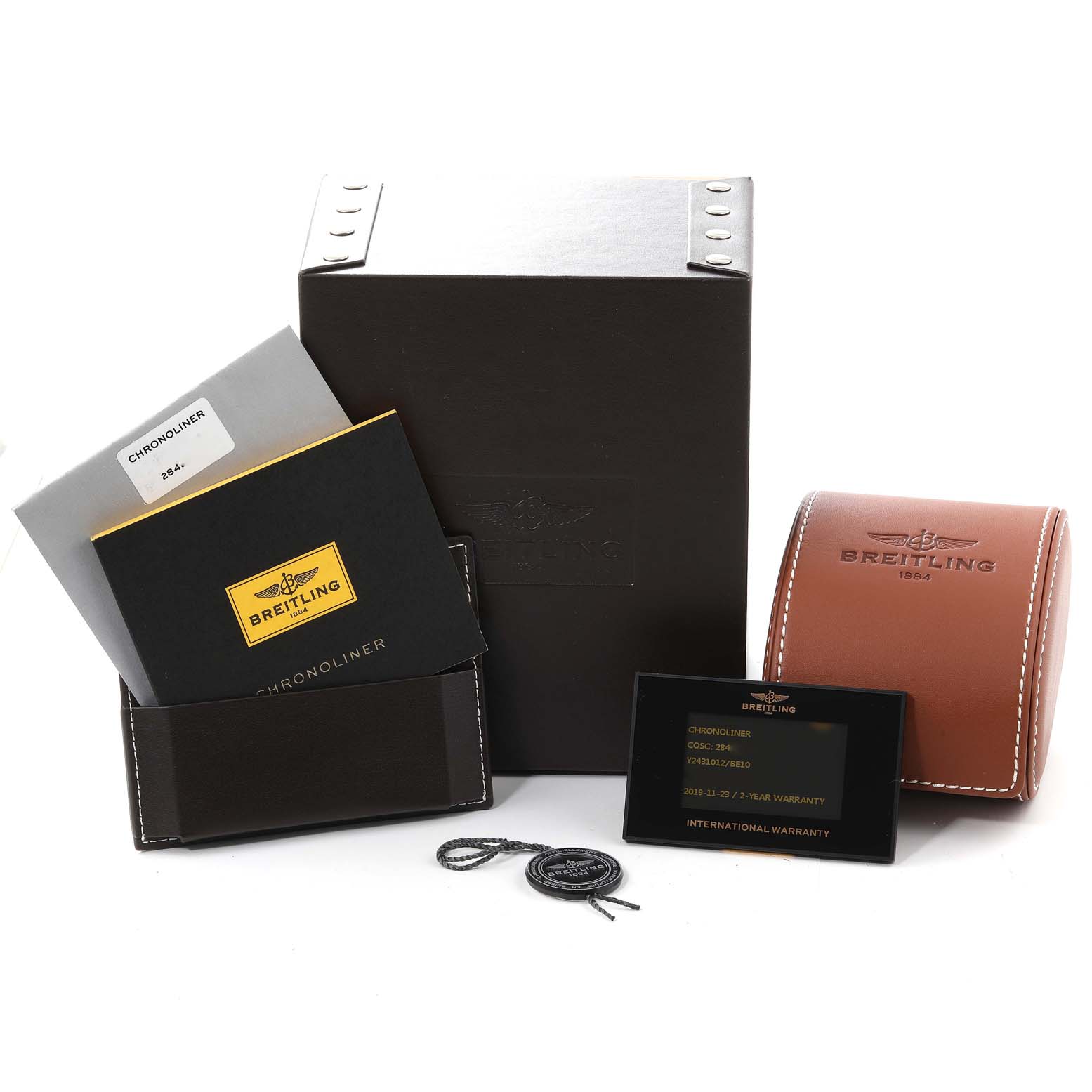 The image shows the Breitling Chronoliner Y2431012/BE10 Men's Stainless Steel Black Dial Y2431012/BE10 Men's Stainless Steel Black Dial packaging, including the box, warranty card, documents, and a leather case, all from a frontal angle.