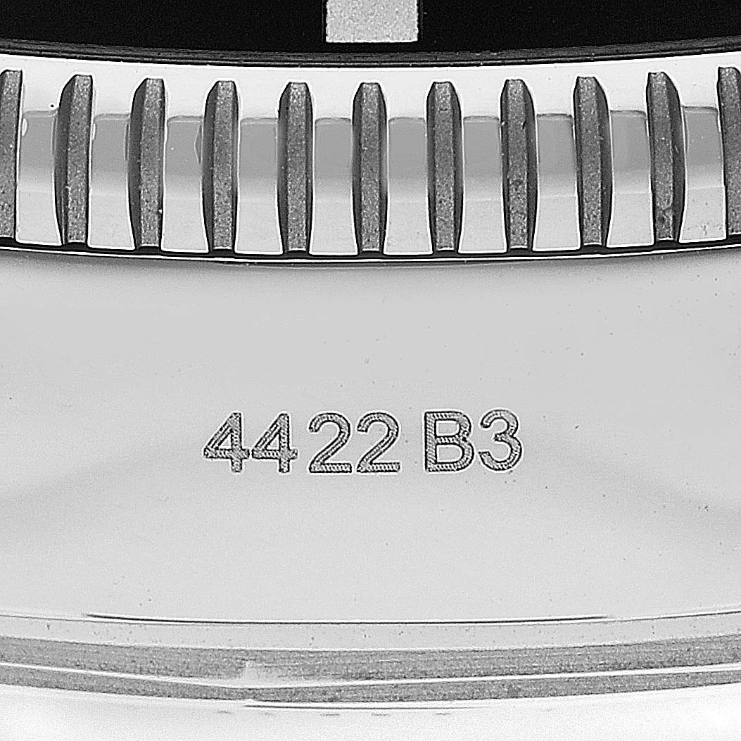 This image shows the serial number and part of the bezel of a Breitling Superocean AB2010 Men's Stainless Steel Green Dial AB2010 Men's Stainless Steel Green Dial watch at an angled close-up view.