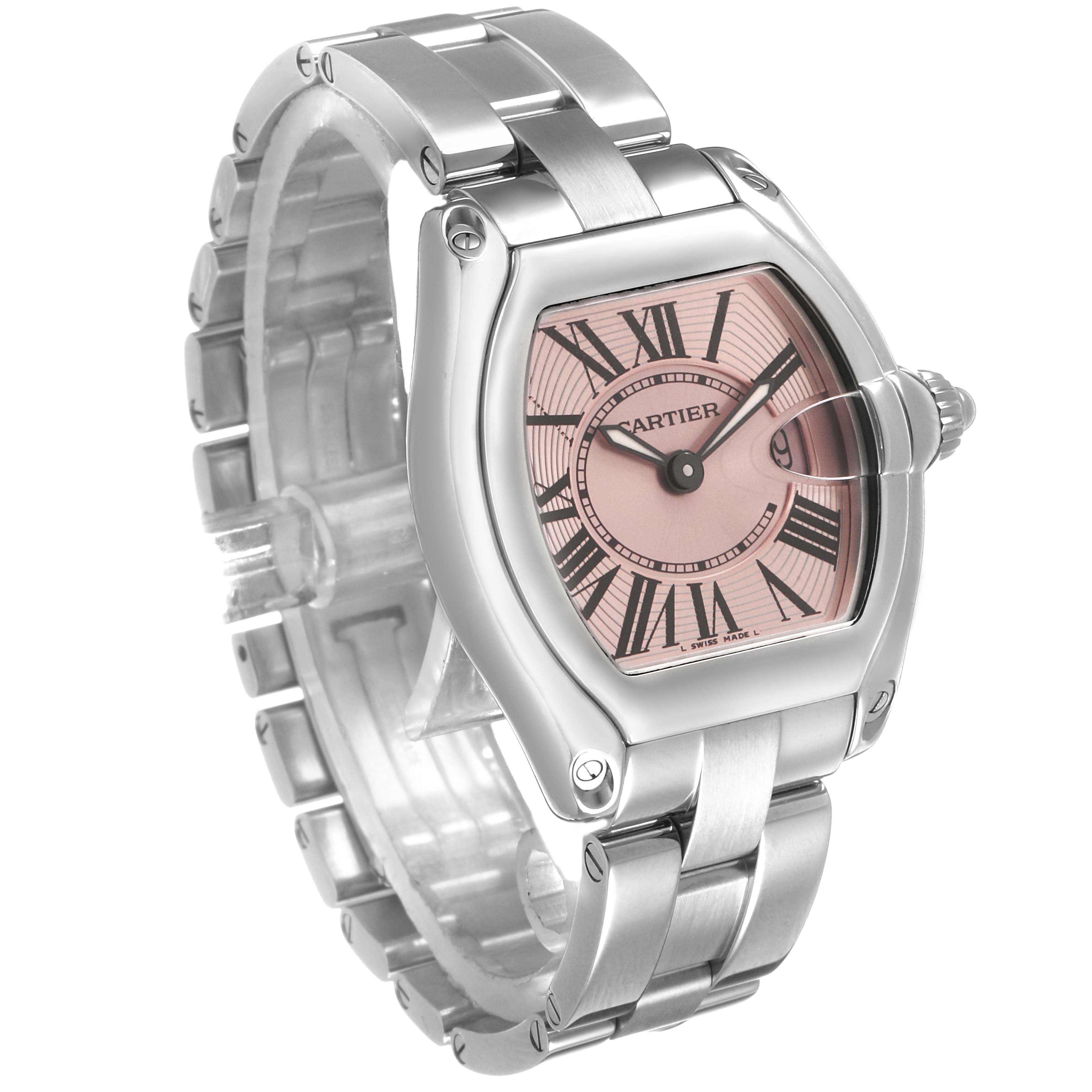 The Cartier Roadster W62017V3 Women's Stainless Steel Pink Dial watch is shown at an angled side view, highlighting the case, bracelet, and pink dial with Roman numerals.