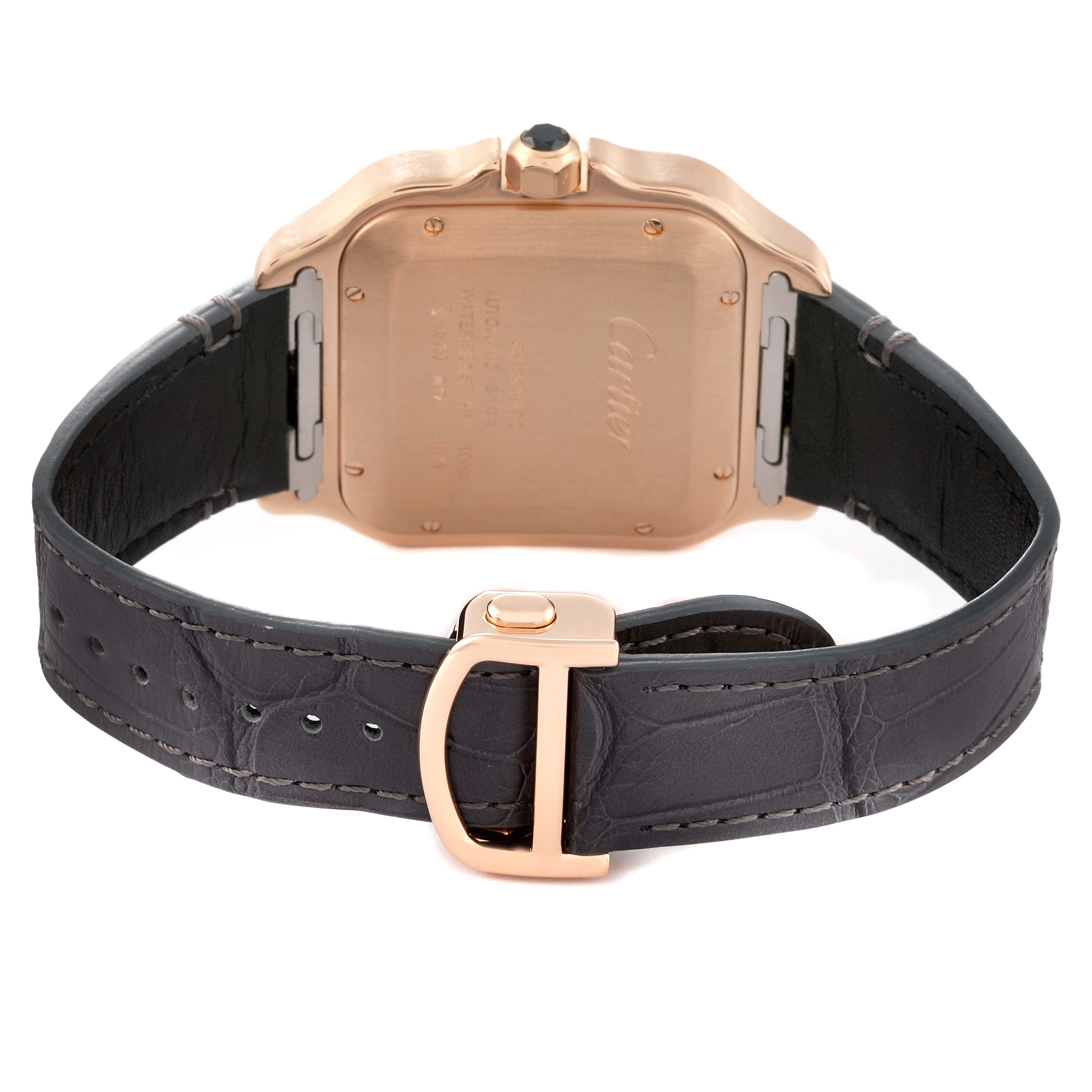 The image shows the back view of a Cartier Santos WGSA0019 Men
s Rose Gold Silver Dial WGSA0019 Men
s Rose Gold Silver Dial watch, highlighting its case back and leather strap with a clasp.