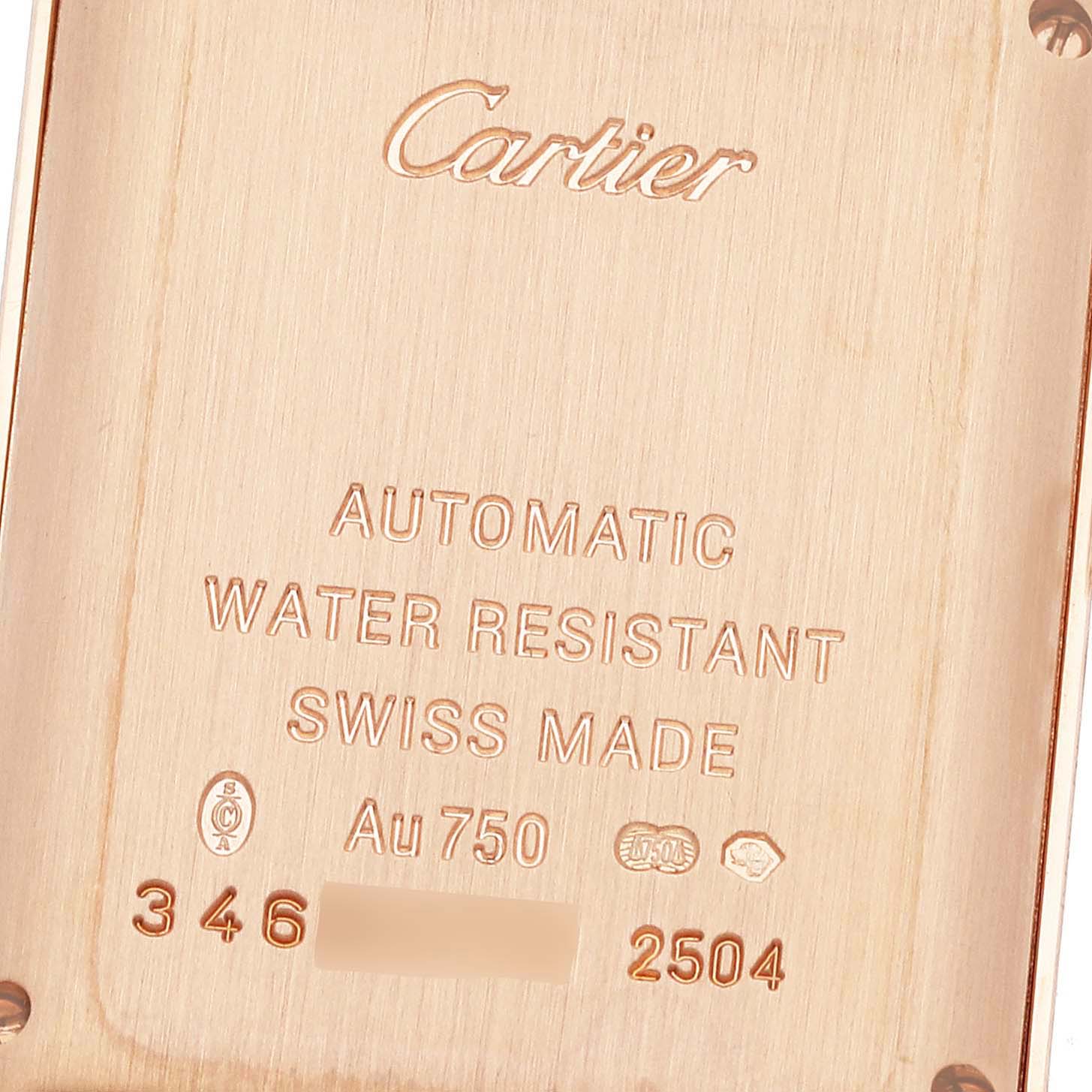 This image shows the back of a Cartier Tank Americaine W2620030 Women
s Rose Gold Silver Dial W2620030 Women
s Rose Gold Silver Dial watch, highlighting its engravings and markings.