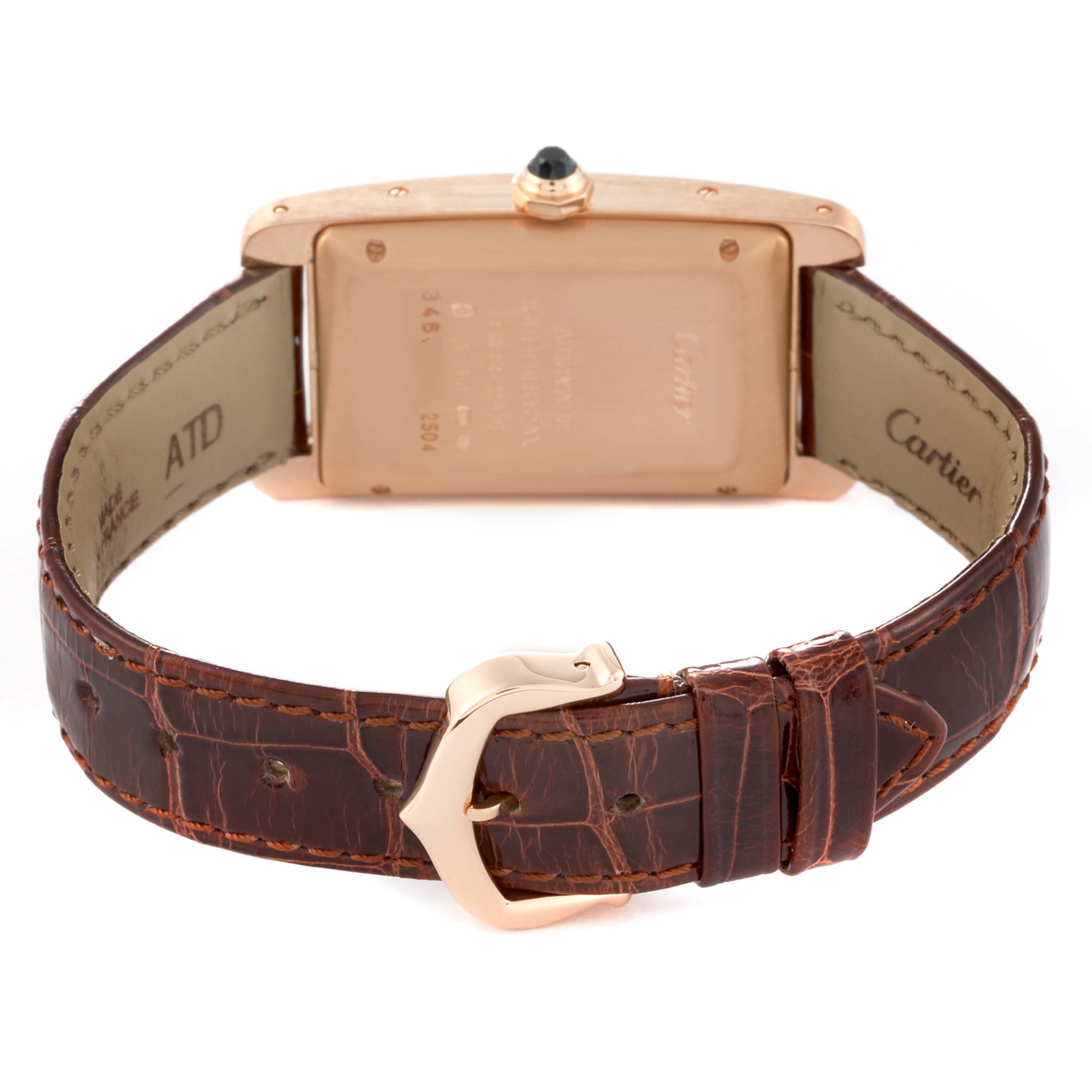 The image shows the back and strap of a Cartier Tank Americaine W2620030 Women
s Rose Gold Silver Dial W2620030 Women
s Rose Gold Silver Dial watch, featuring a gold case and brown leather band with a buckle.