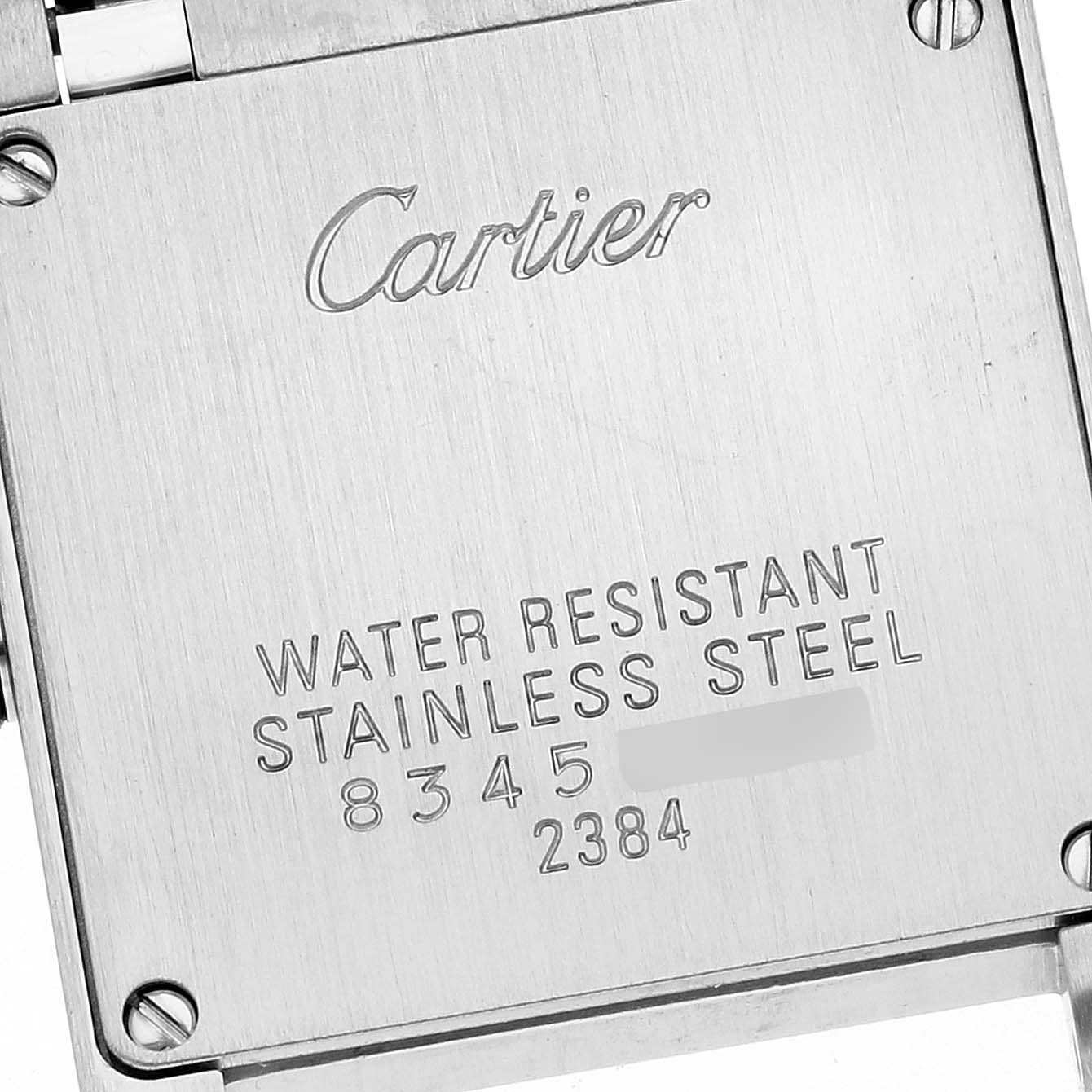 This is a close-up of the back case of a Cartier Tank Française watch, showing the brand name, model, and material details.