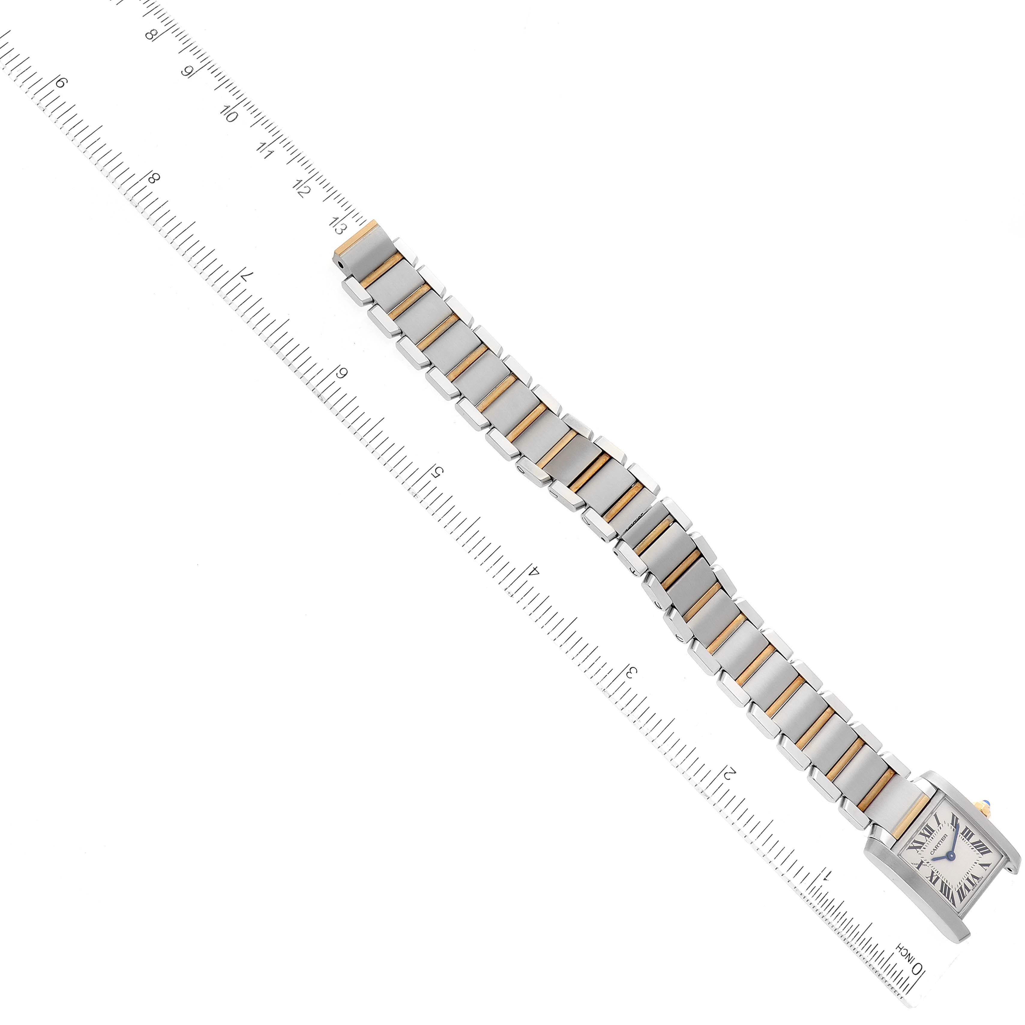 The image shows a top-down view of a Cartier Tank Francaise W51007Q4 Women
s Steel and Gold (two tone) Silver Dial W51007Q4 Women
s Steel and Gold (two tone) Silver Dial watch with a ruler for size reference.