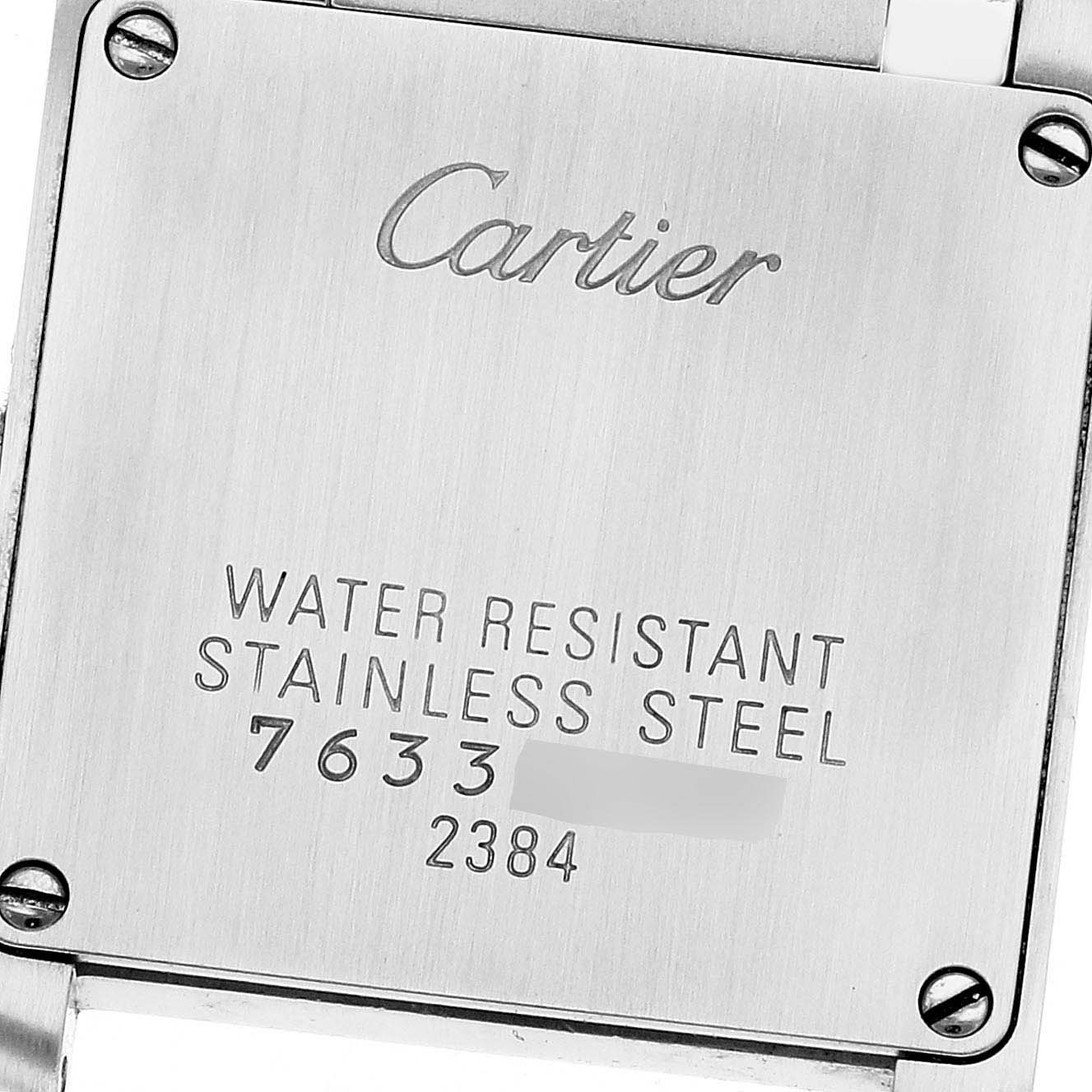 The image shows the case back of a Cartier Tank Française watch, highlighting engraving details and screws.