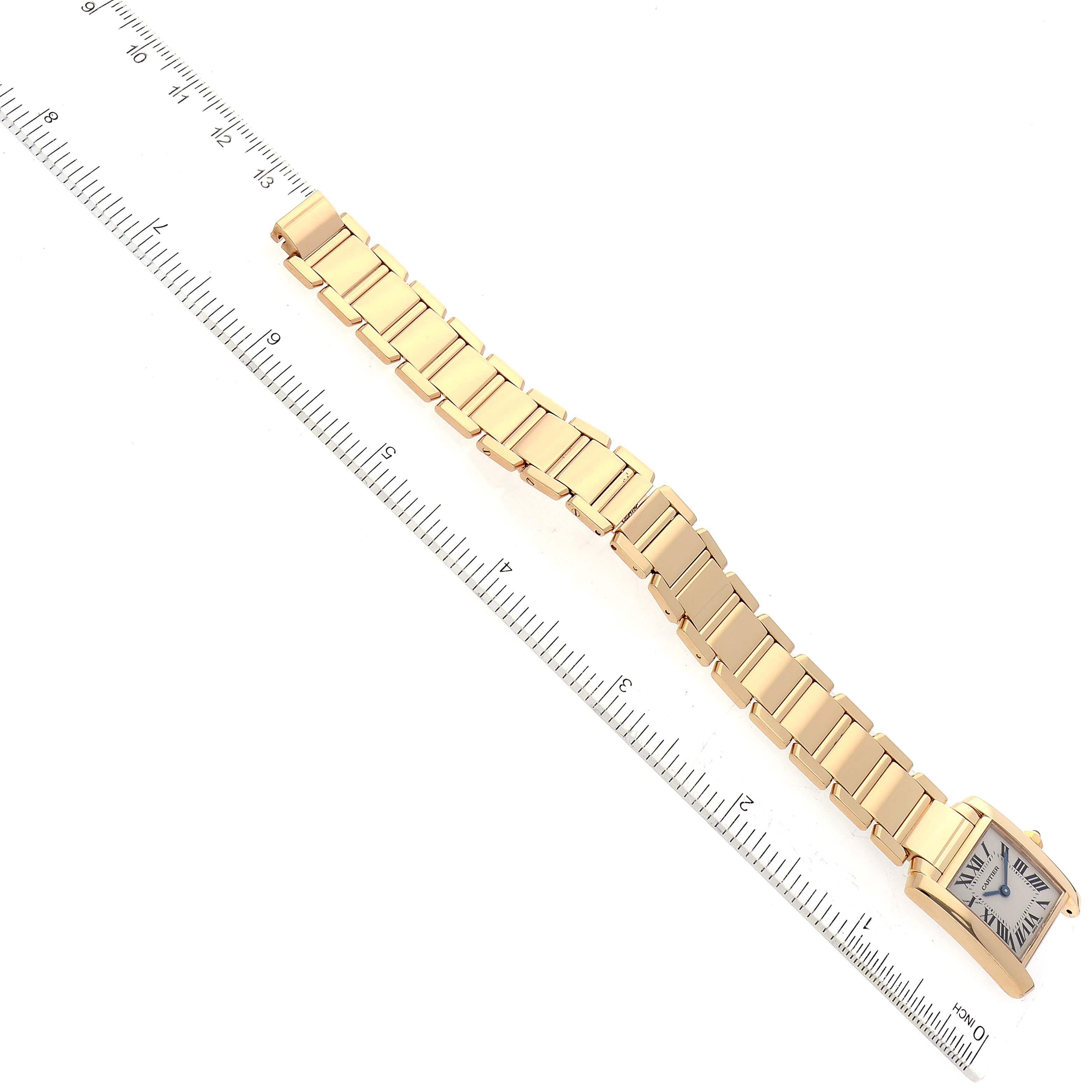 The image shows a Cartier Tank Francaise W50002N2 Women's Yellow Gold Silver Dial W50002N2 Women's Yellow Gold Silver Dial watch at a top-down angle, with a ruler for scale, highlighting the bracelet and face.