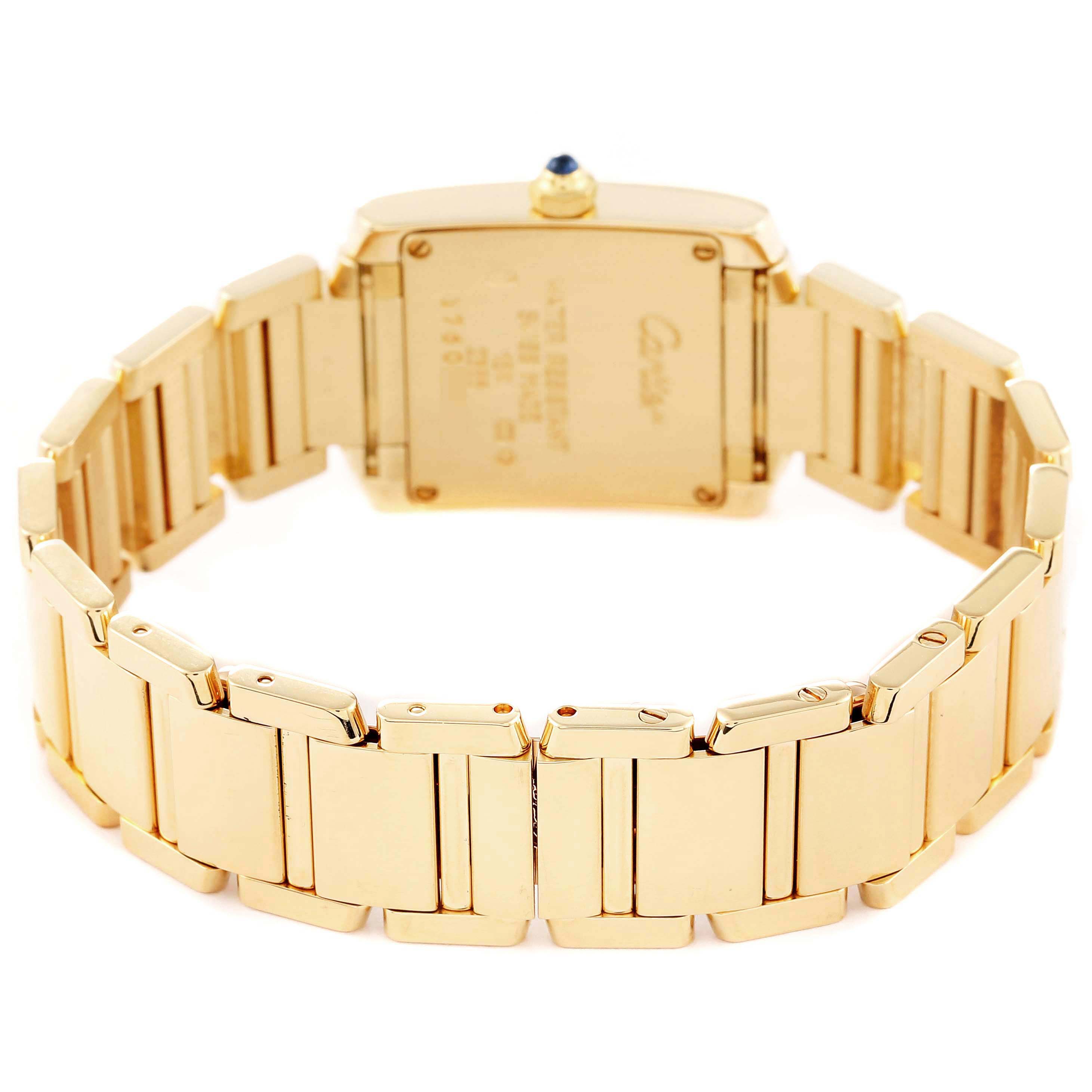 The image shows the back view of a Cartier Tank Française watch, focusing on its gold bracelet and case back.