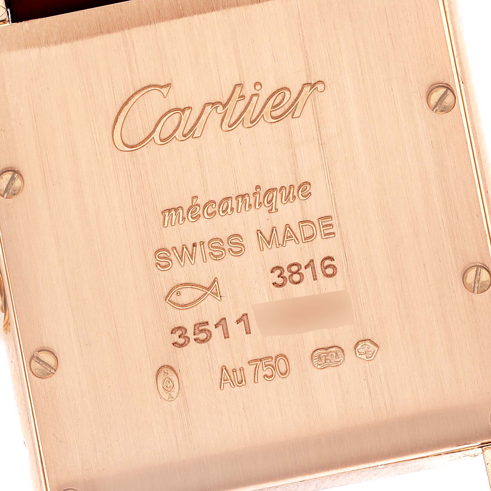 The image shows the case back of the Tank Louis watch by Cartier, highlighting its engravings and markings.